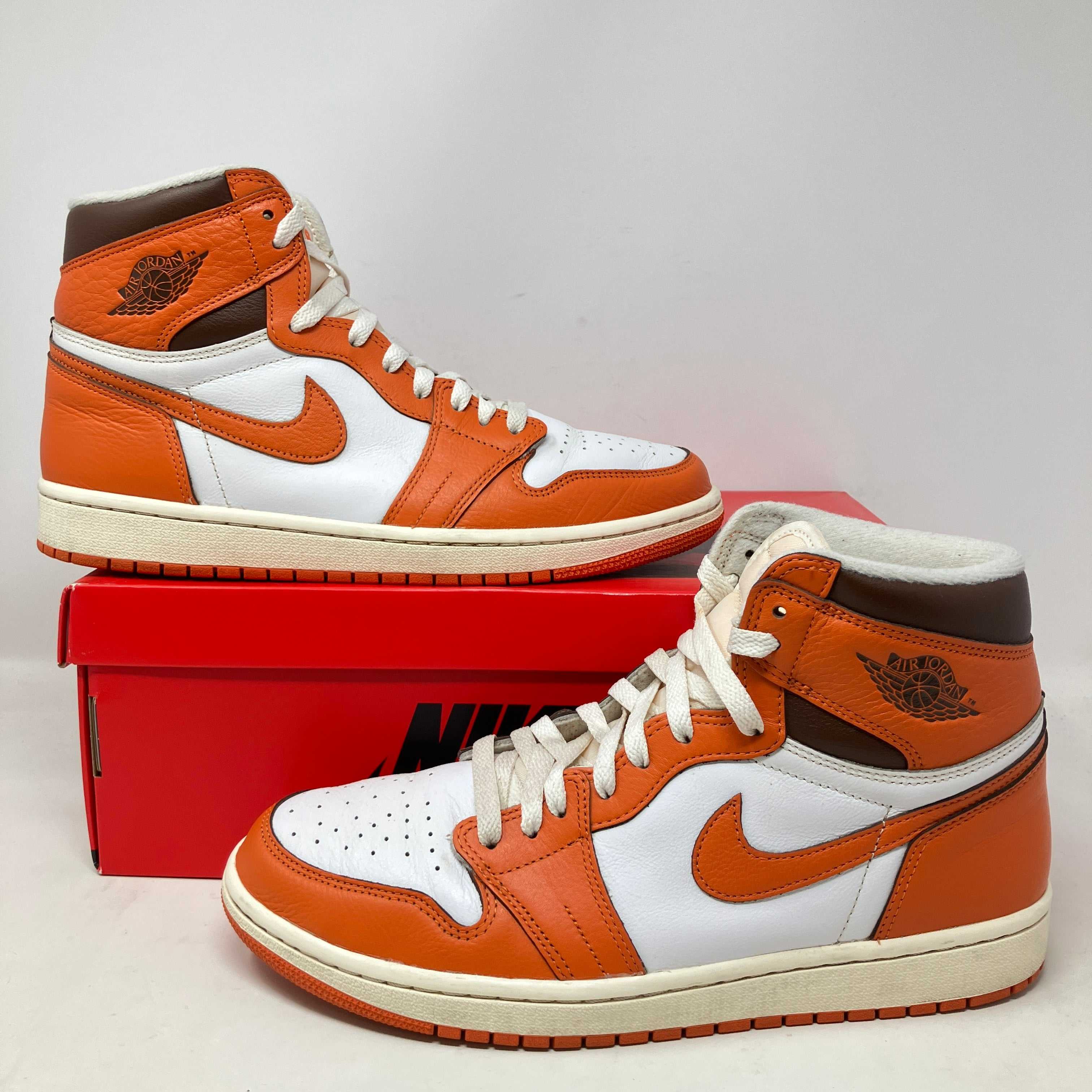 Pair of Air Jordan 1 High OG Shattered Backboard sneakers in orange, white, and black on red Nike box, 2025 release