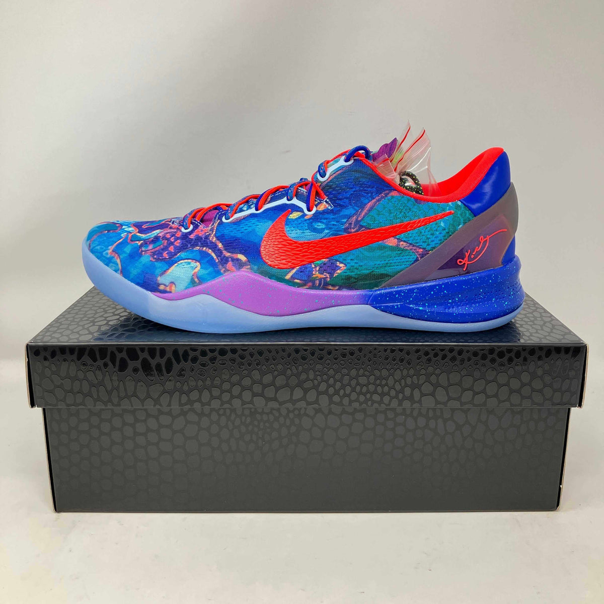 Nike Kobe 8 Protro low-top basketball shoe featuring vibrant blue, red, and purple with a multicolor abstract pattern and red swoosh logo.