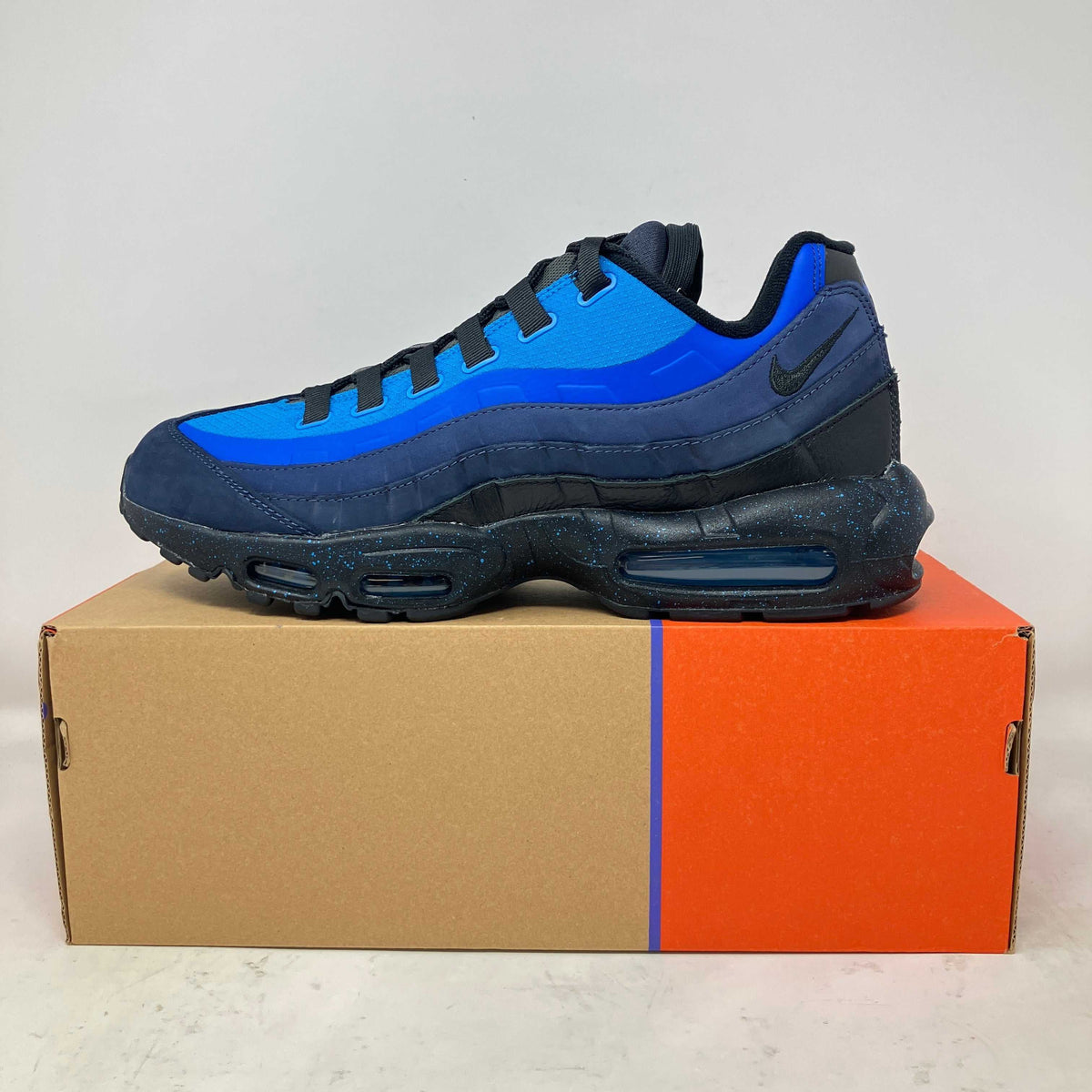 Nike Air Max 95 Stash sneaker in blue and black with suede and mesh materials and a speckled black sole.