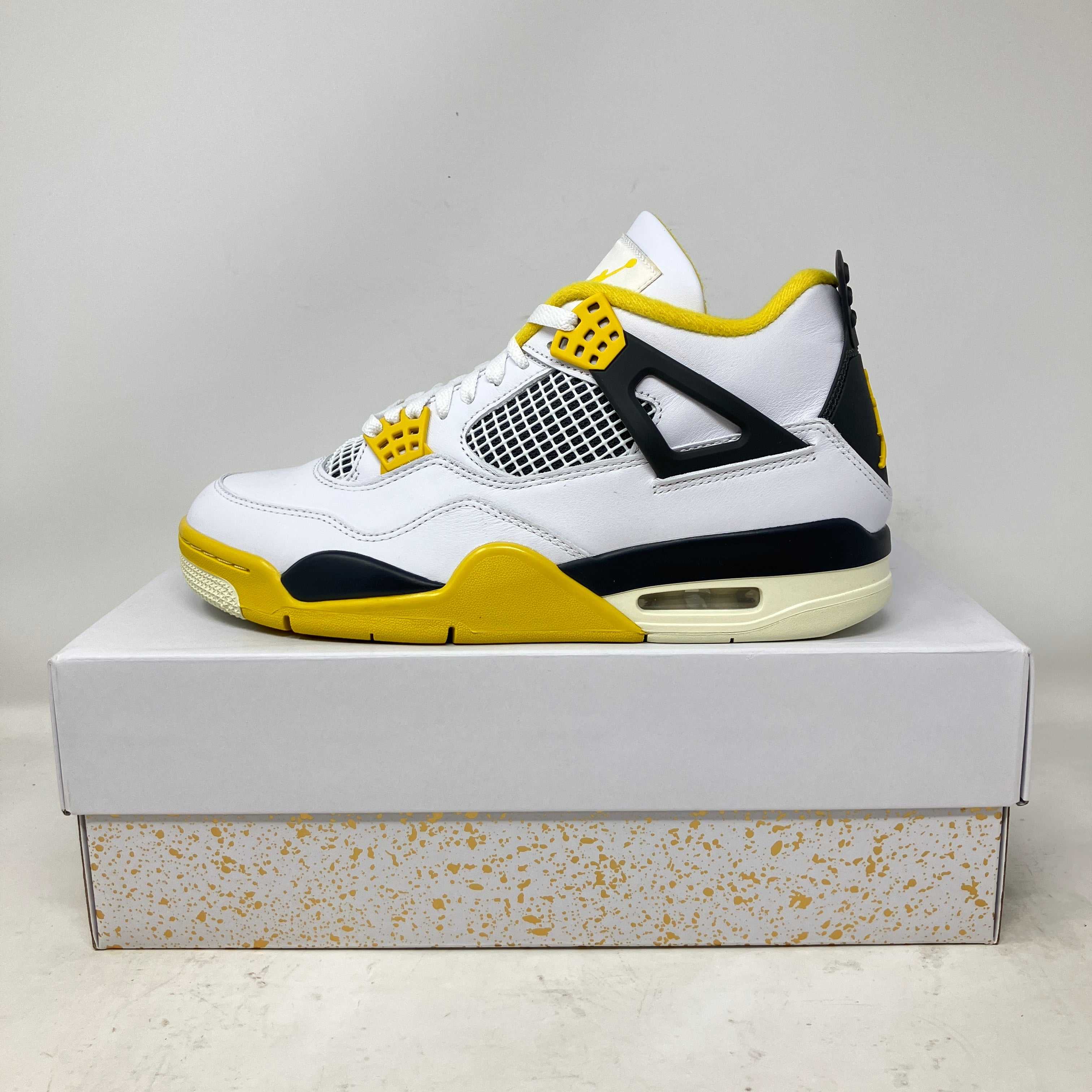 Jordan 4 Retro Vivid Sulfur women's sneaker in white, yellow, and black on a box