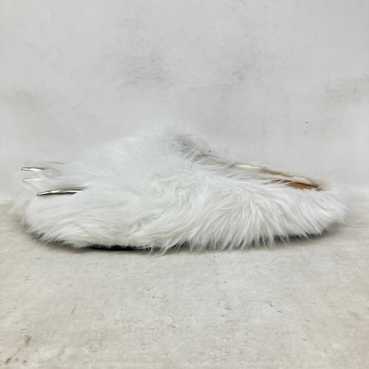 Bravest Studios white mule with long faux fur and distinctive silver bear claw details on the toe area