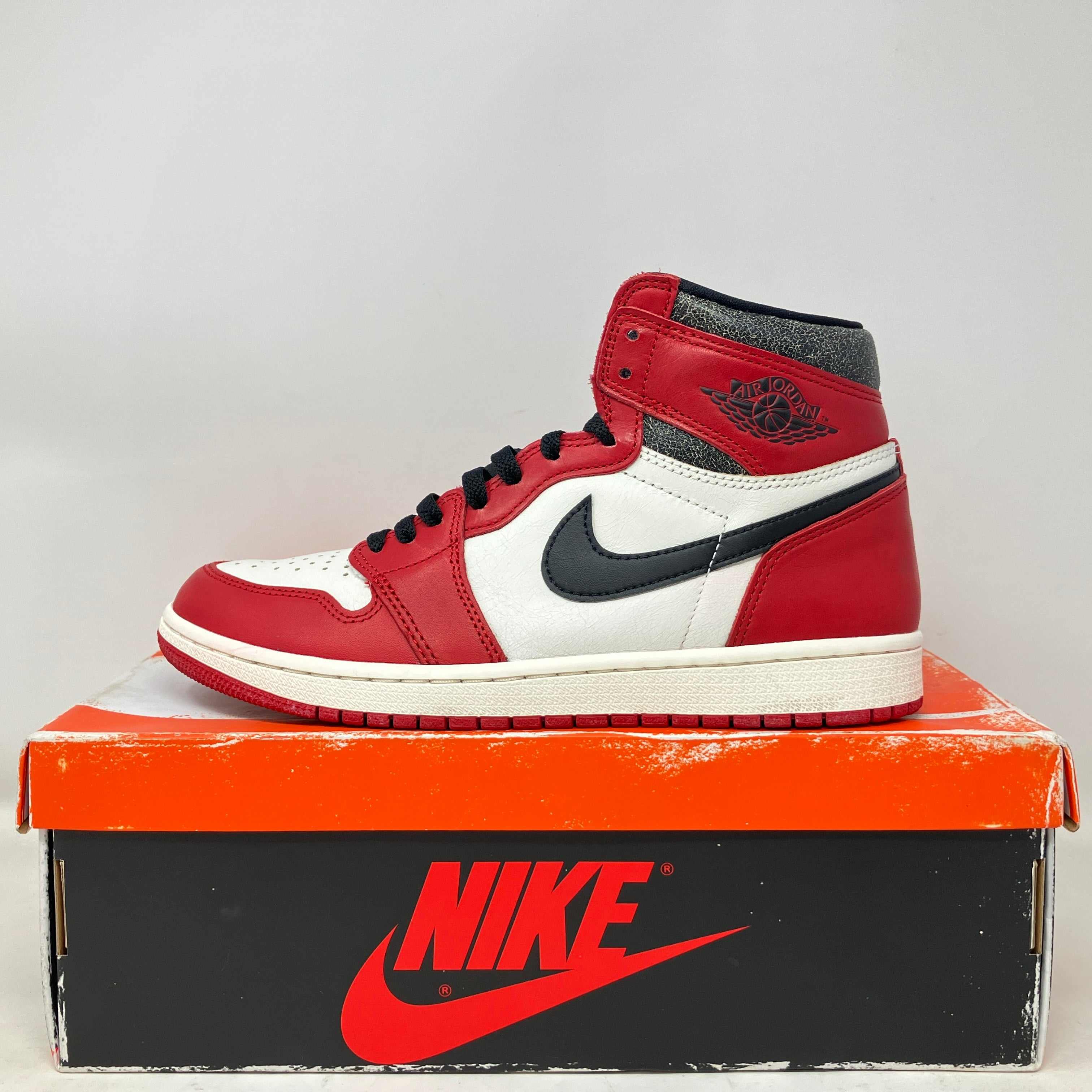 Jordan 1 Retro High OG Chicago Lost and Found sneaker on Nike box, pre-owned condition