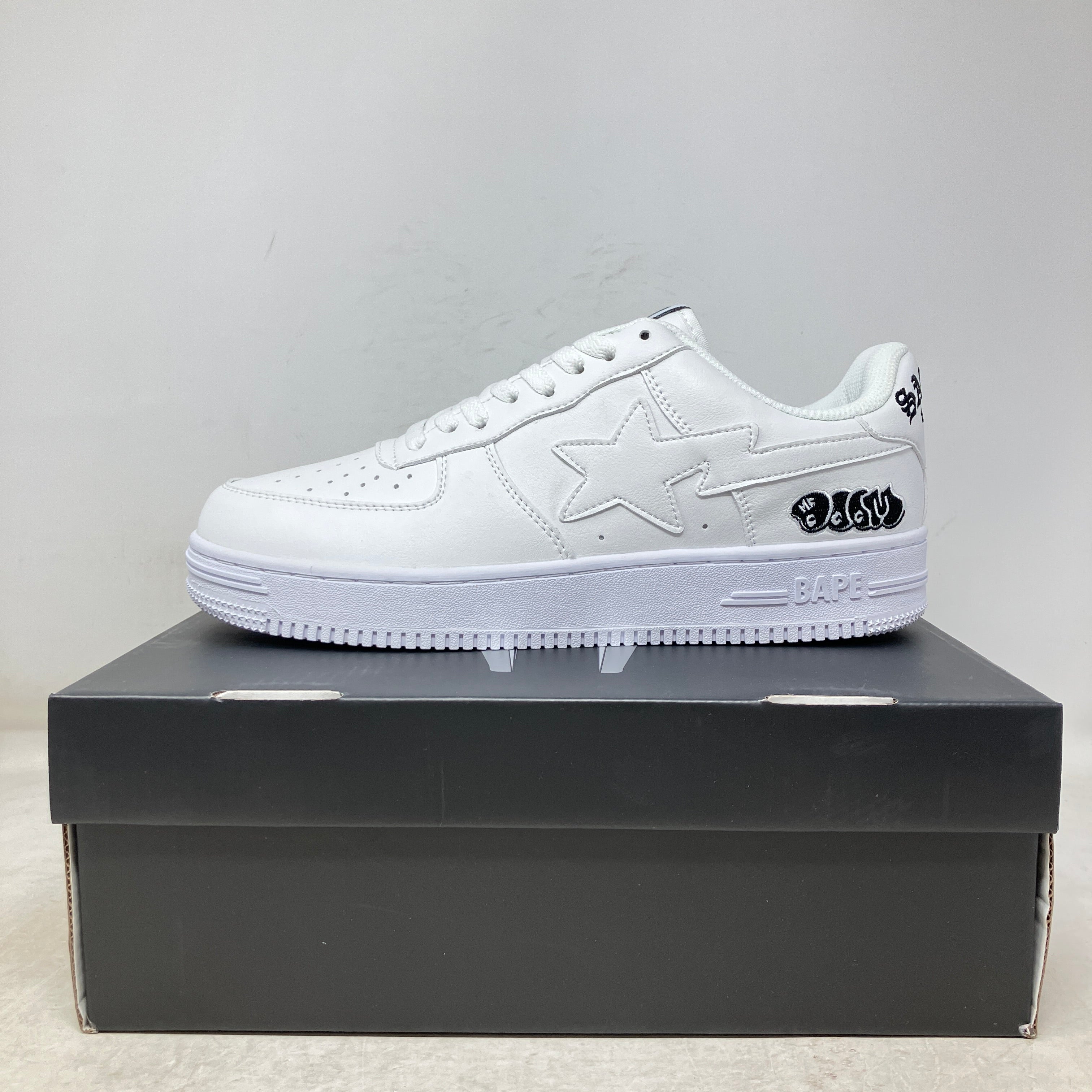 Savior Studios white leather low-top sneaker with tonal star panels, embossed sole and small black heel accents