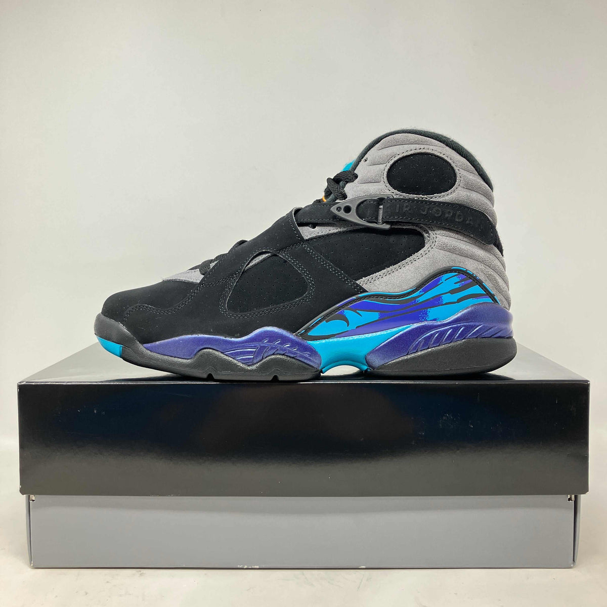Jordan 8 Retro Aqua basketball shoe in black, grey, and aqua blue with purple accents and a high-top suede design.