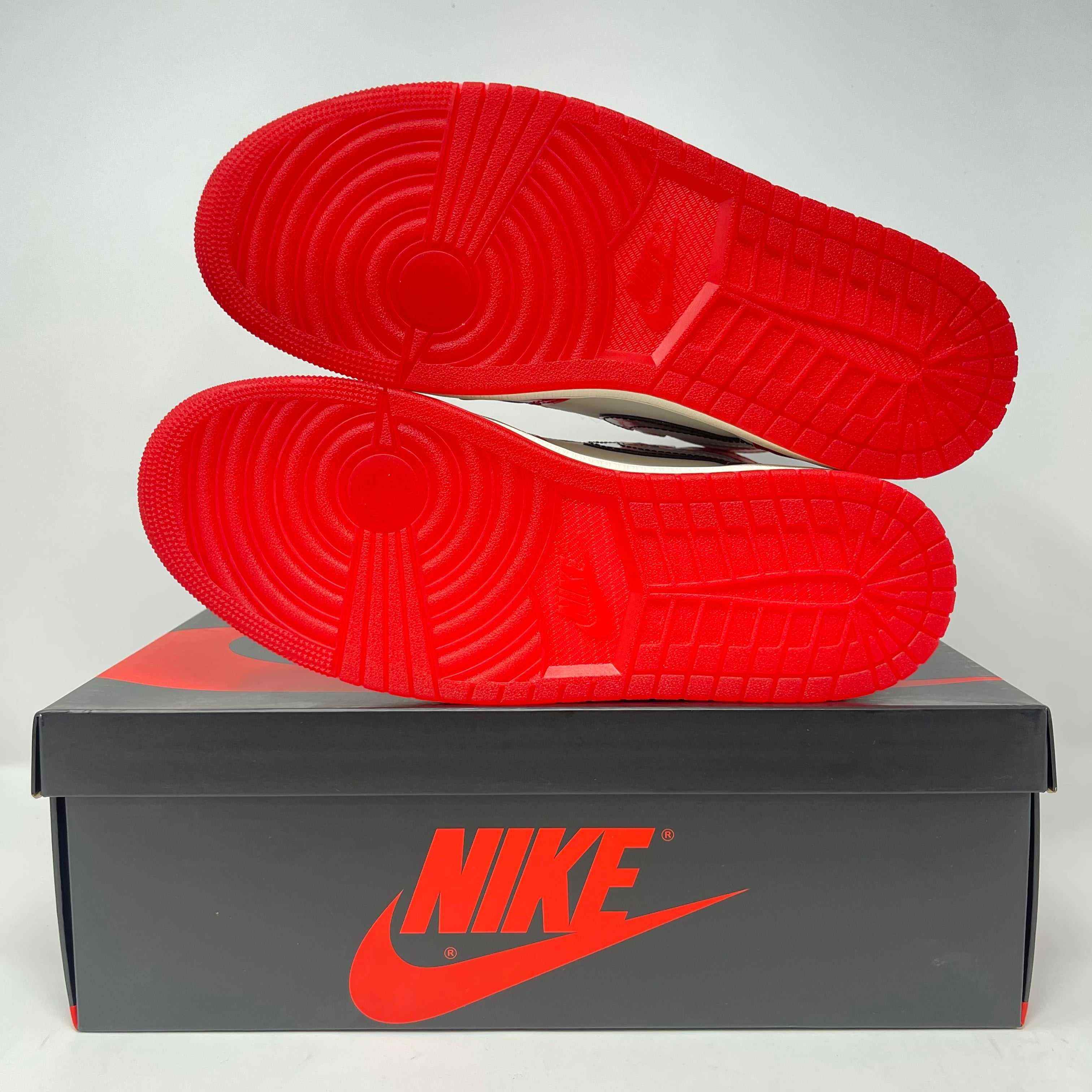 Jordan 1 Retro High OG Spider-Man sneakers on Nike box with red soles.