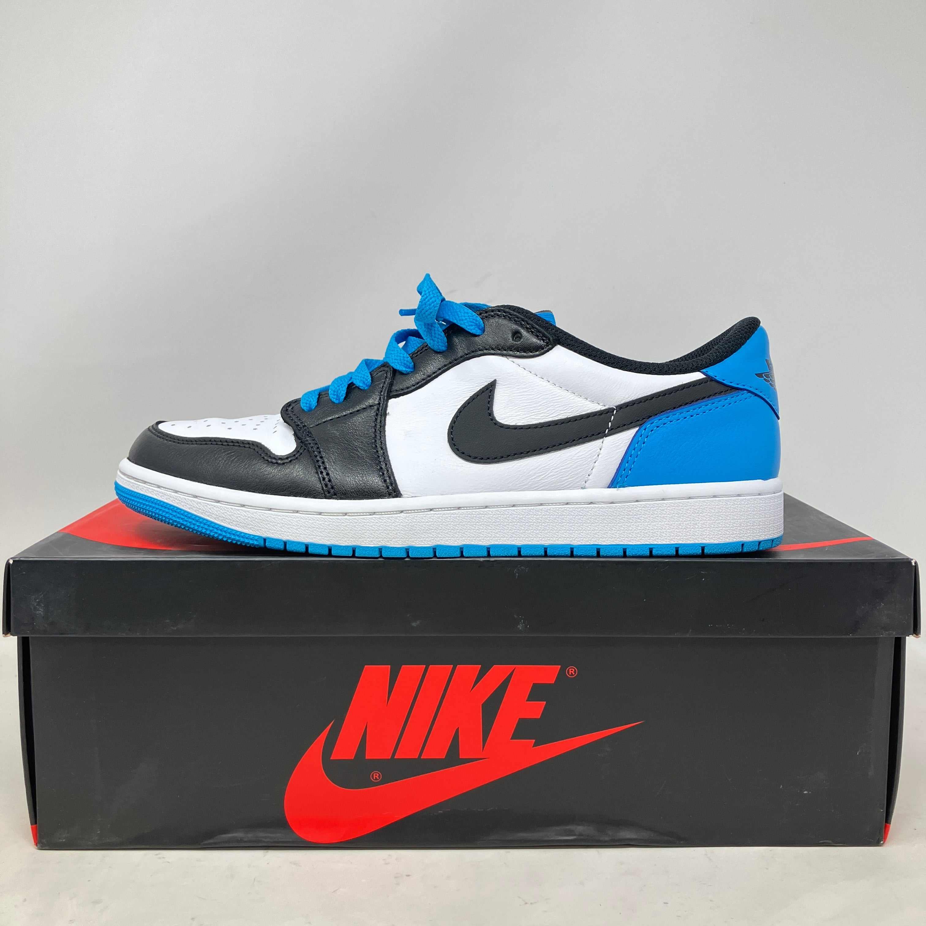 Jordan 1 Retro Low OG Black Dark Powder Blue sneaker on Nike box, pre-owned condition with all accessories included