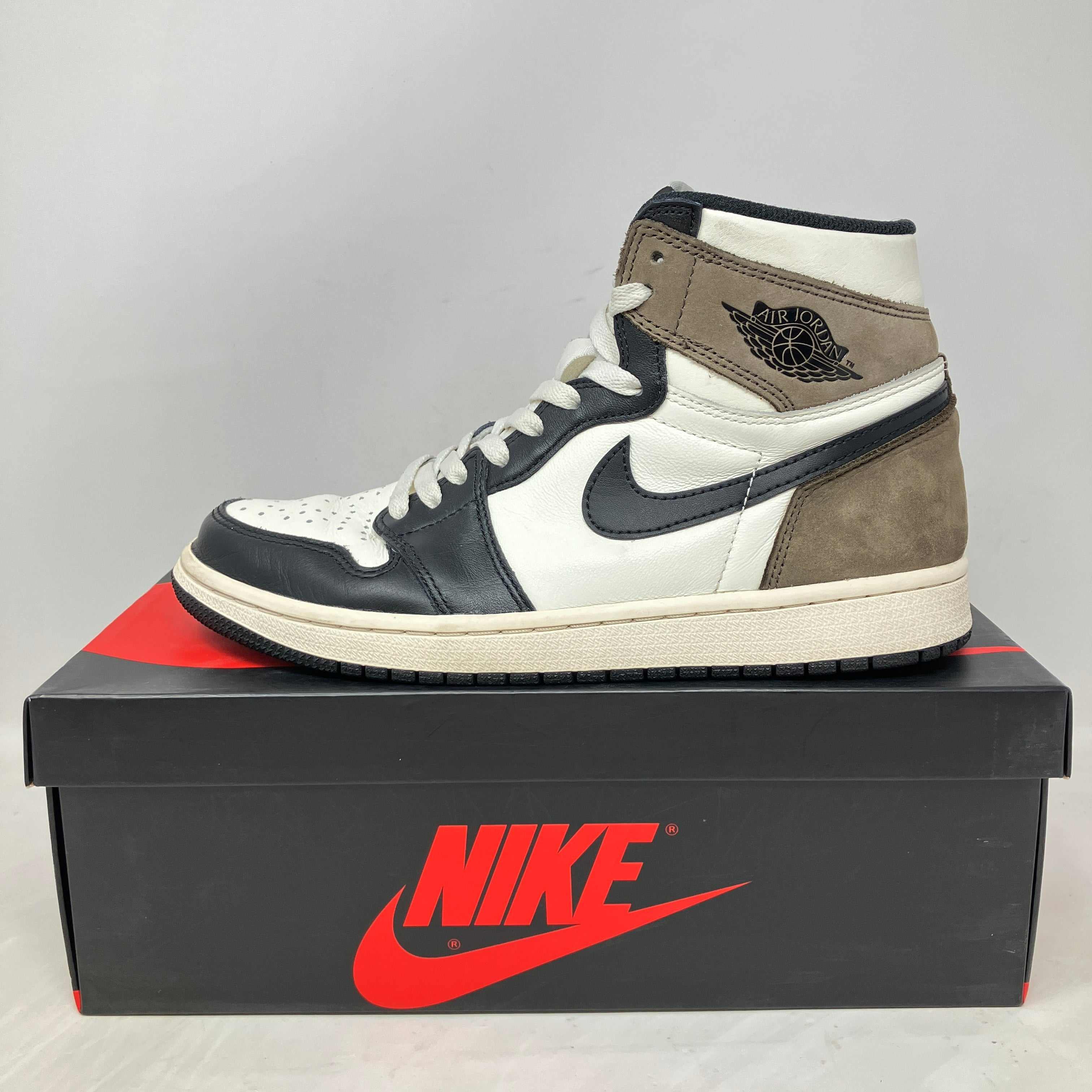 Jordan 1 Retro High Dark Mocha sneaker on Nike box, pre-owned condition with missing black laces