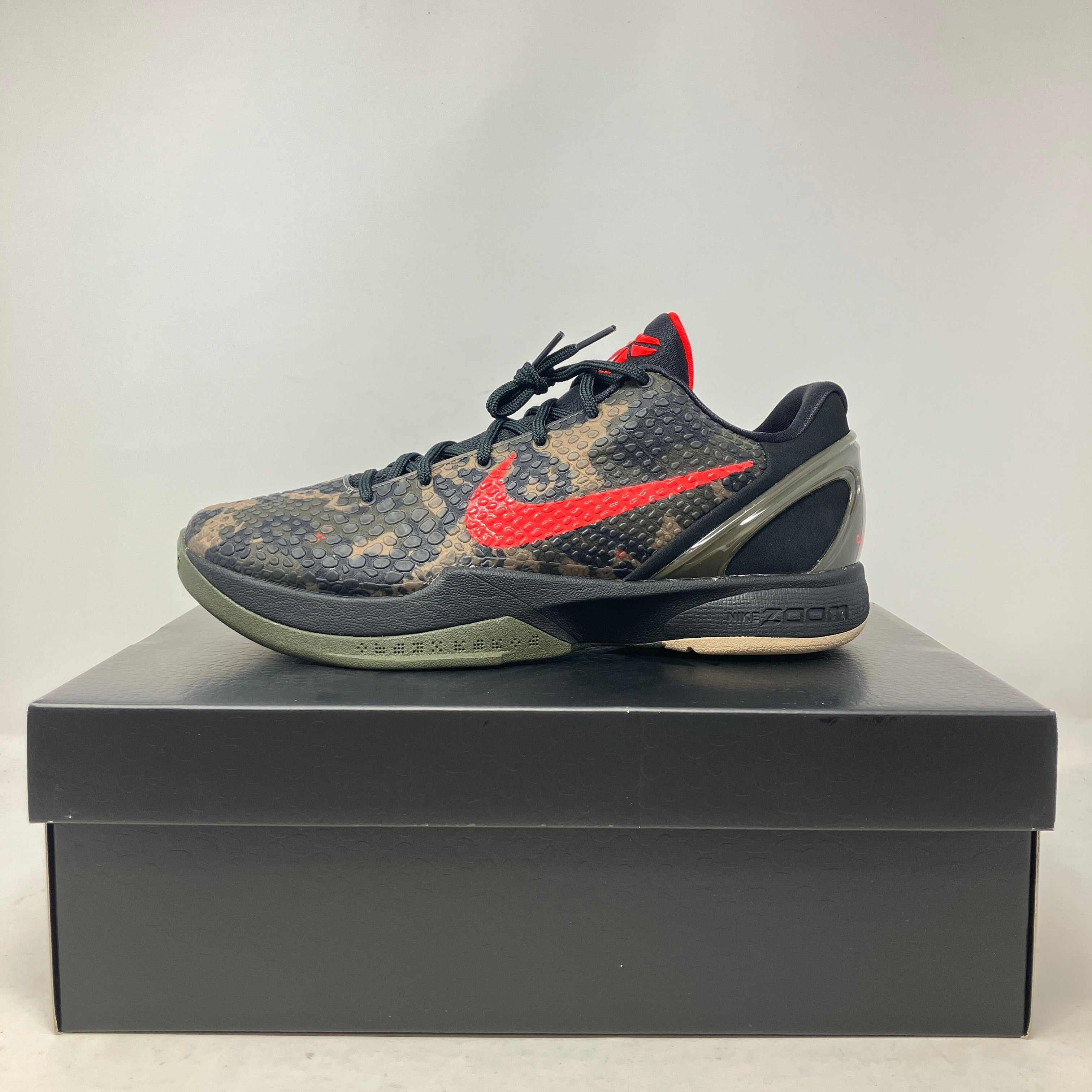 Nike Kobe 6 Protro Italian Camo basketball shoe in black and olive with red swoosh on black shoebox.
