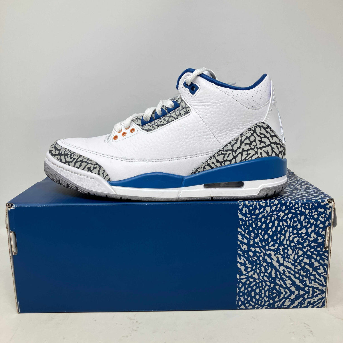 Jordan 3 Retro Wizards sneaker in white leather with blue accents, gray-and-black elephant-print overlays and visible Air unit.