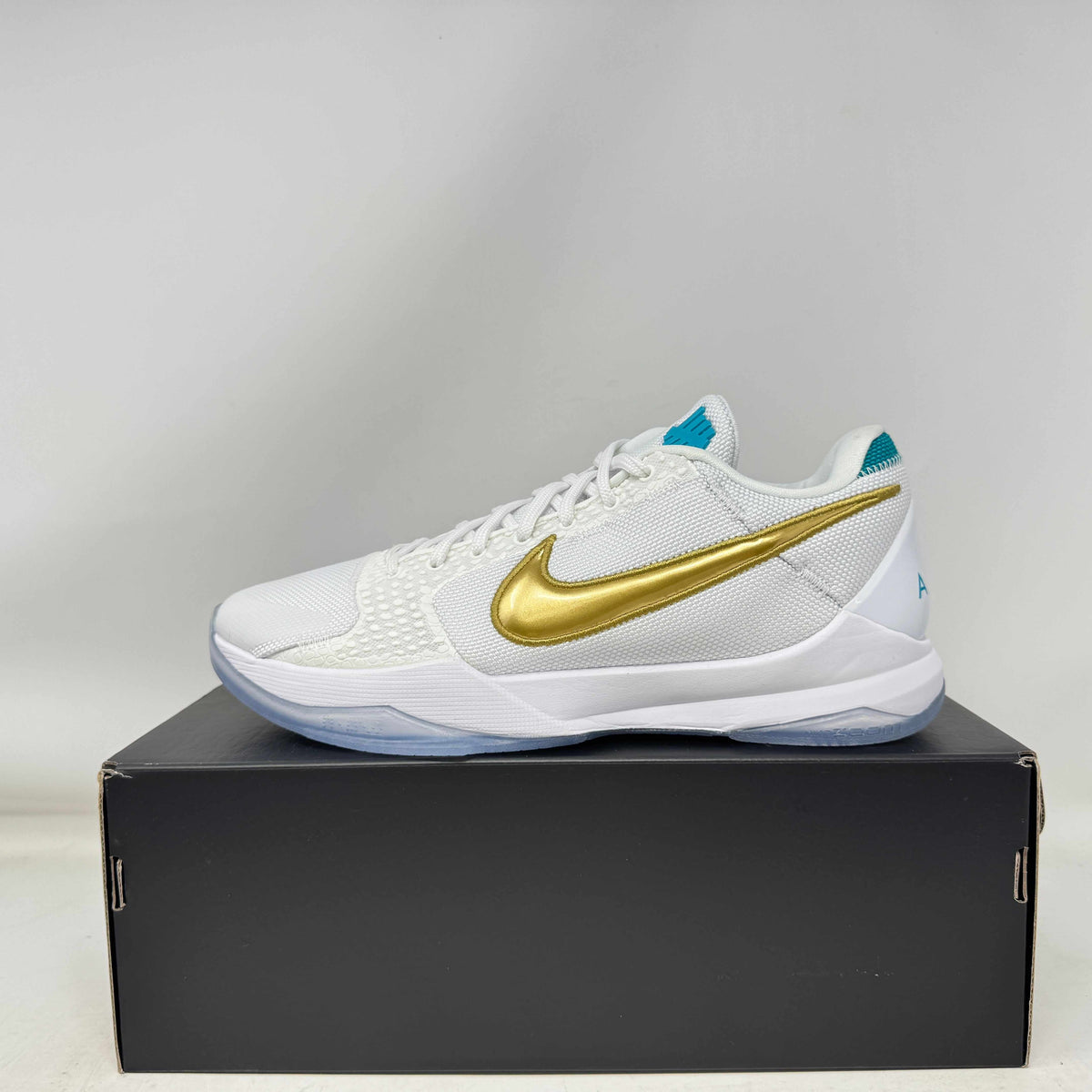 Nike Kobe 5 Protro Undefeated What If White sneakers, brand new, with gold swoosh and replacement box.