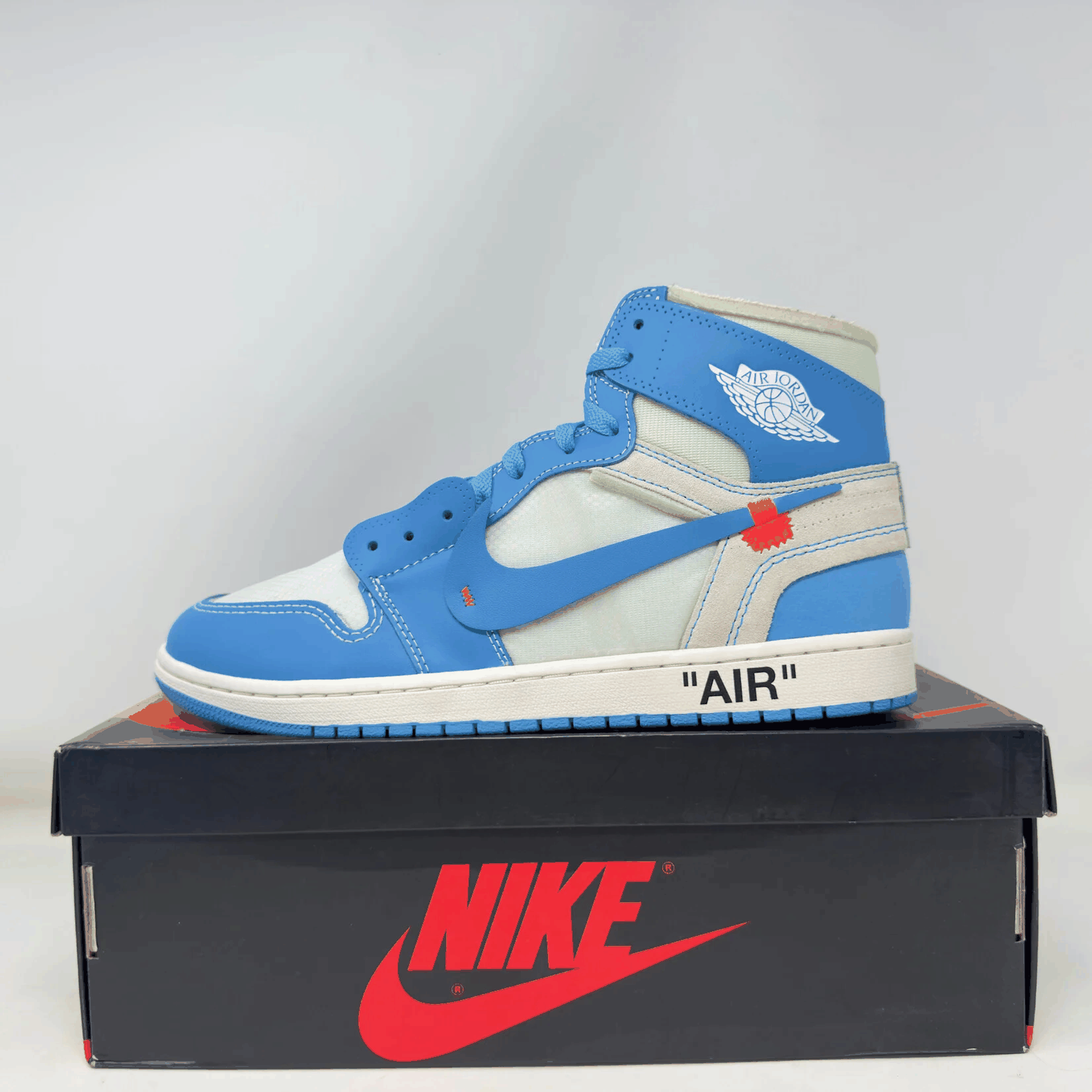 Jordan 1 Retro High Off-White University Blue sneaker on Nike box with blue and white colorway