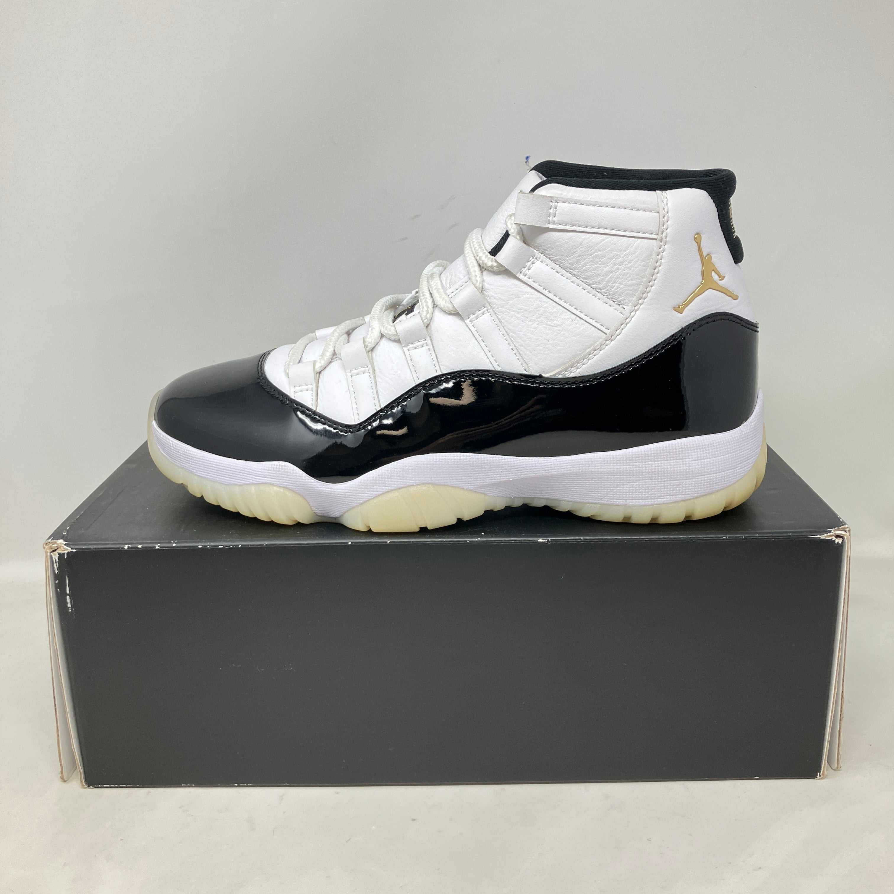 Pre owned Jordan 11 Retro DMP Gratitude sneaker in black and white with gold Jumpman logo on black box
