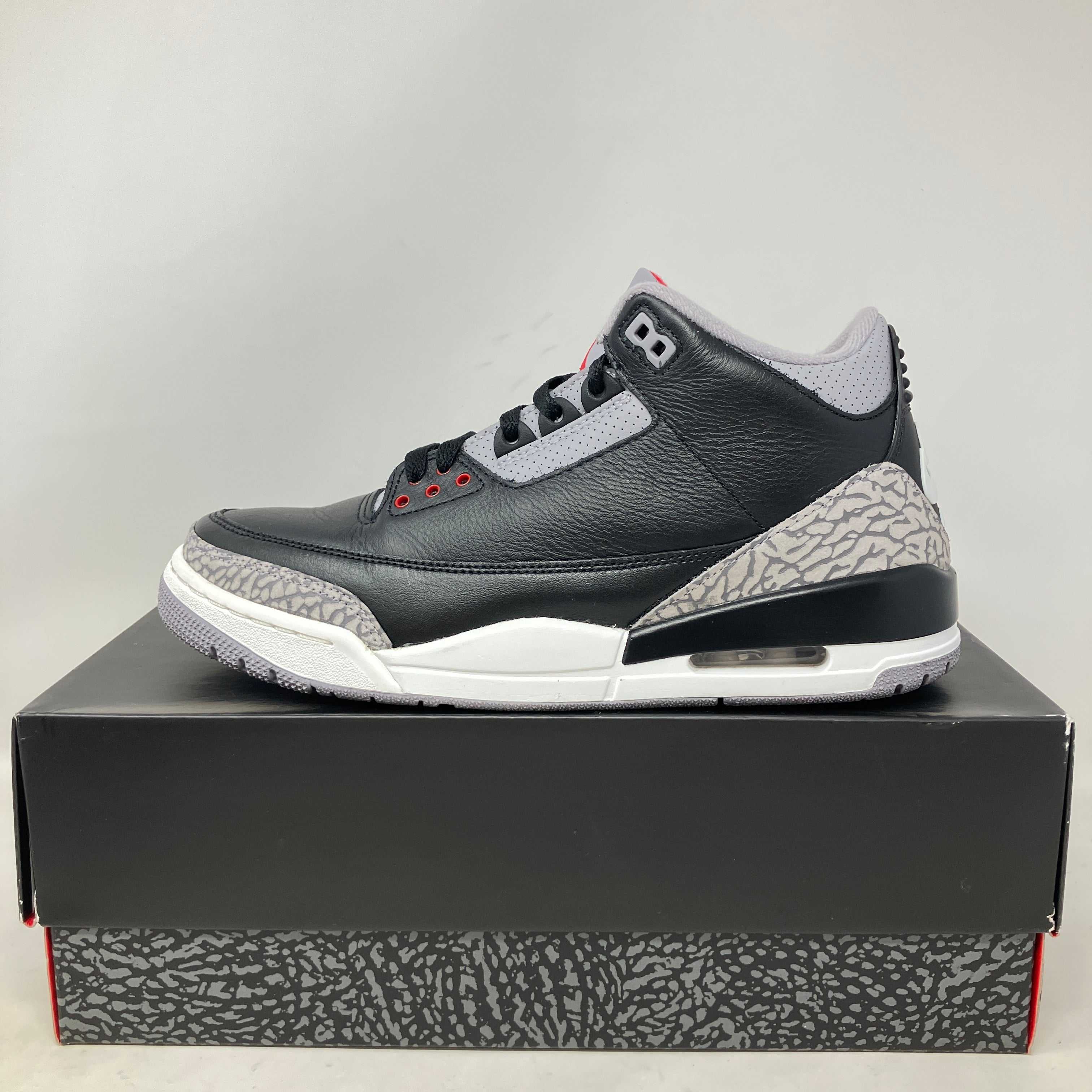 Jordan 3 Retro OG Black Cement sneaker side view on box pre-owned with accessories