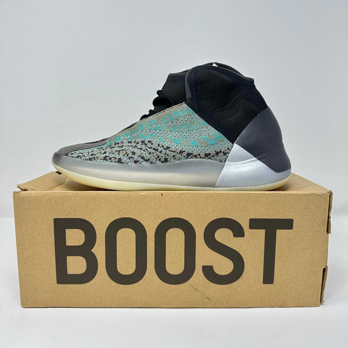 adidas Yeezy QNTM high-top sneaker in teal blue and black knit with translucent sole and metallic silver detailing