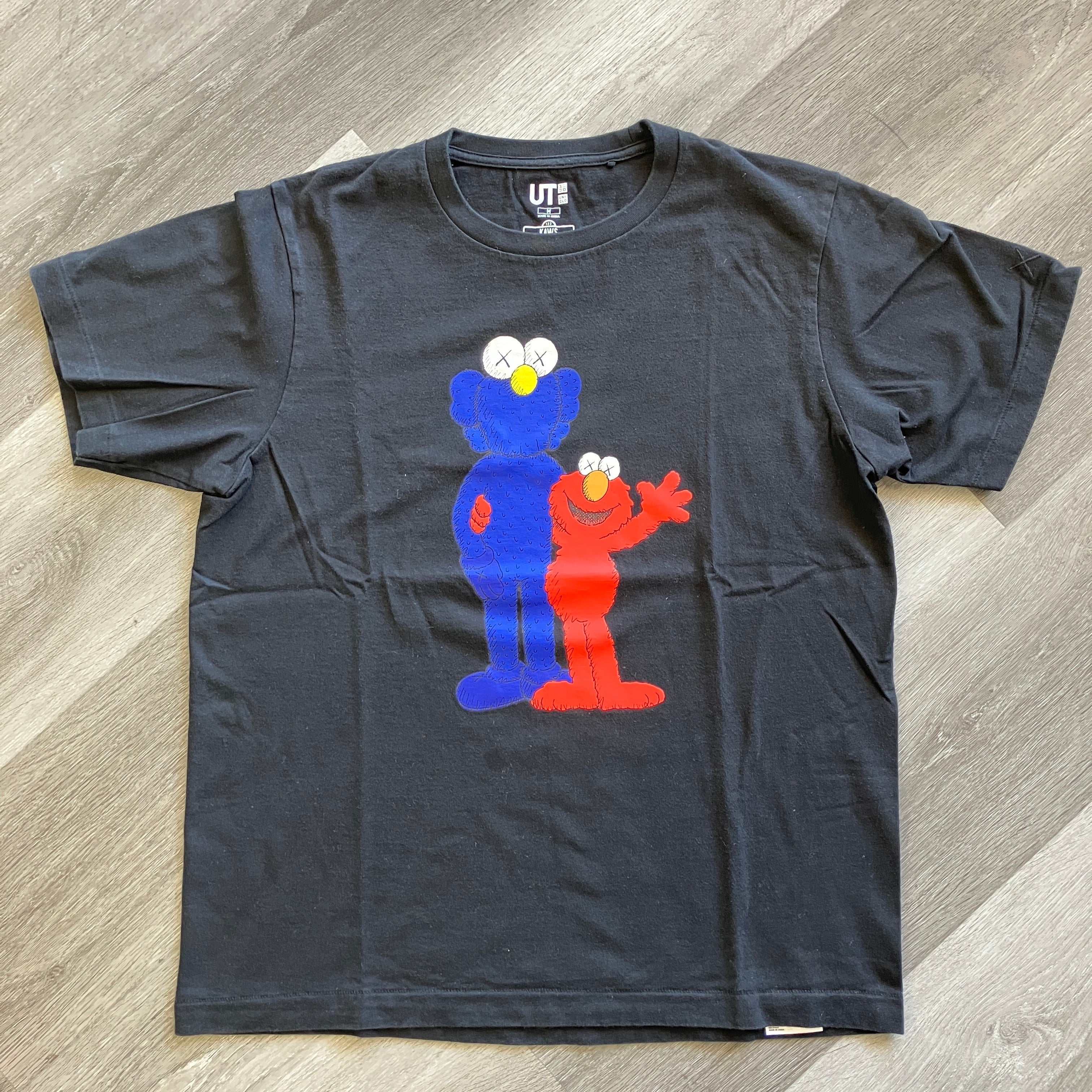 KAWS x Uniqlo black tee with Sesame Street Elmo and blue character graphic, pre-owned, 21" pit to pit, 24.5" length