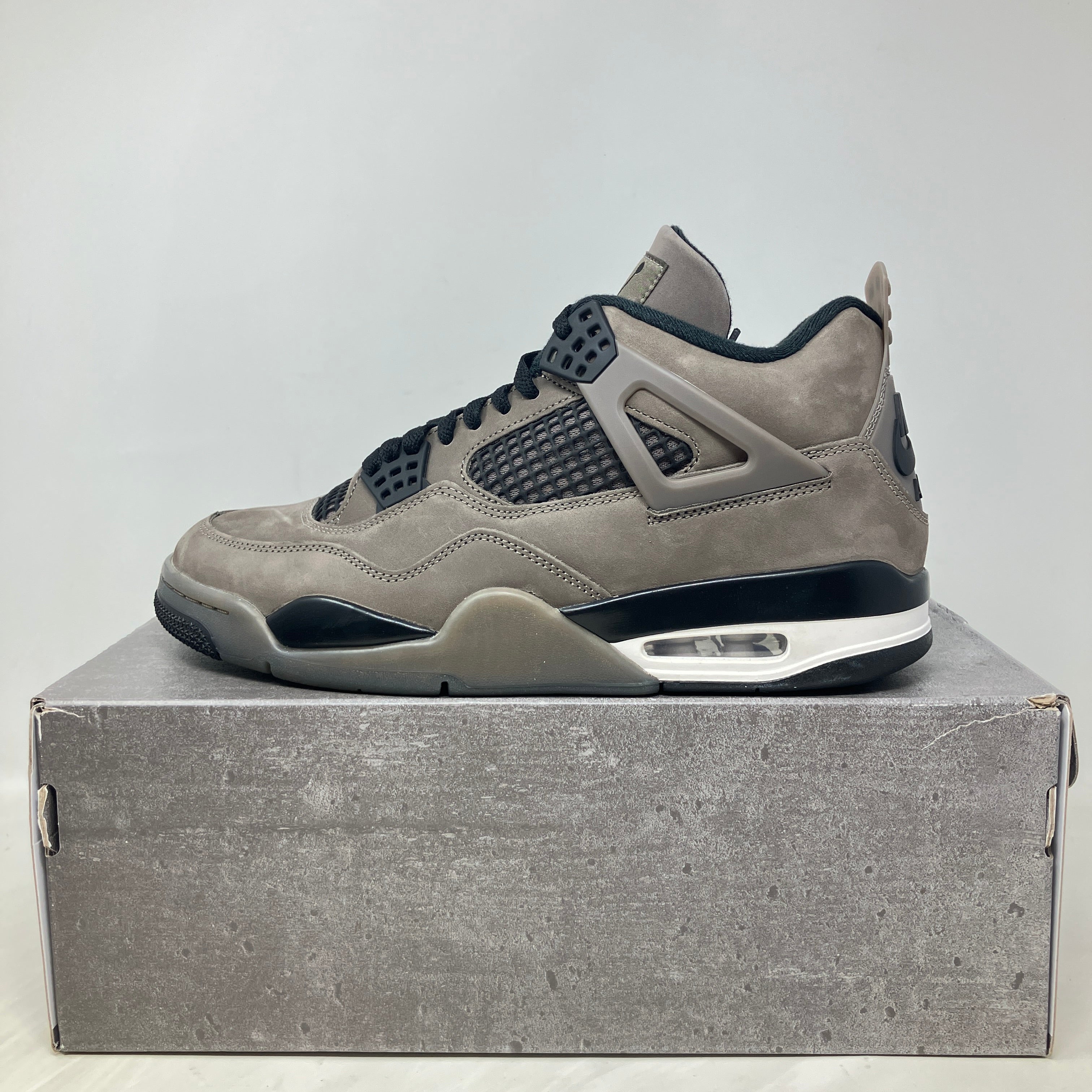 Jordan 4 Retro Cave Stone sneaker in pre-owned condition with all accessories on gray box
