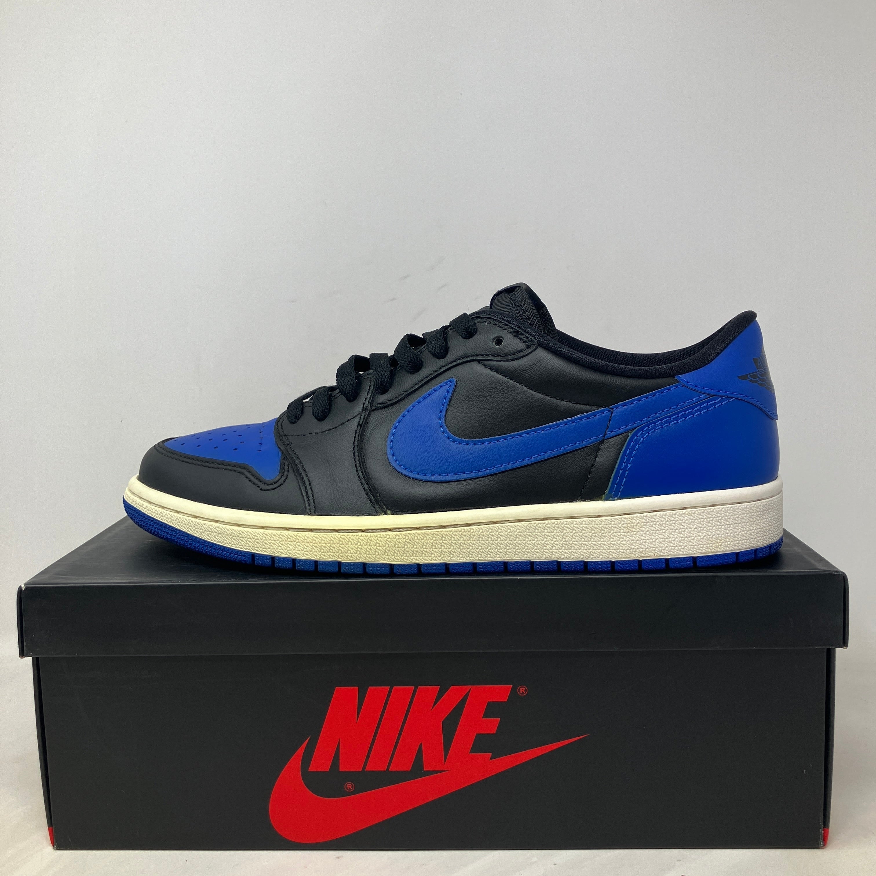 Jordan 1 Retro Low Royal 2015 sneaker in black and blue on Nike box, pre-owned condition