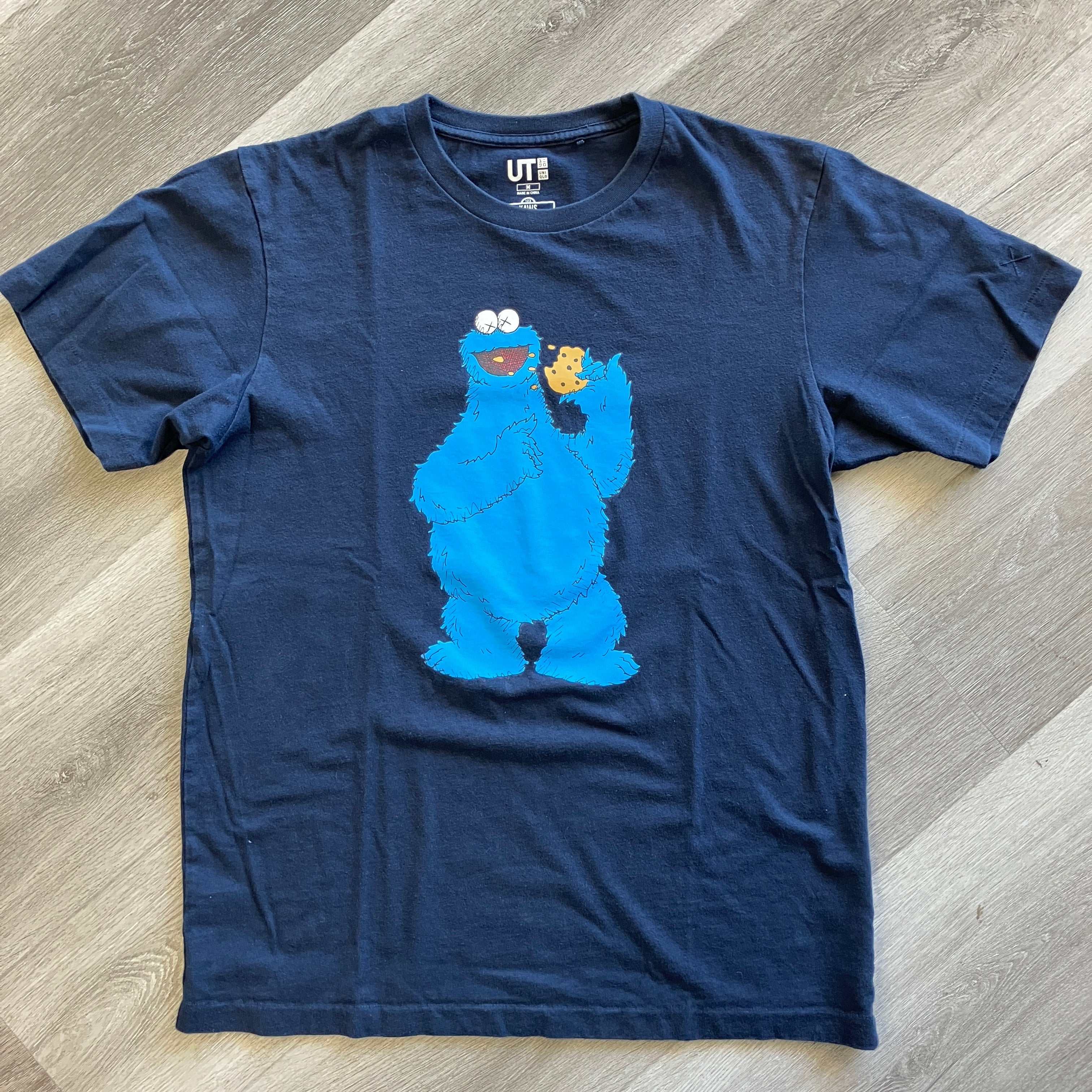 KAWS x Uniqlo x Sesame Street navy tee featuring Cookie Monster graphic pre-owned
