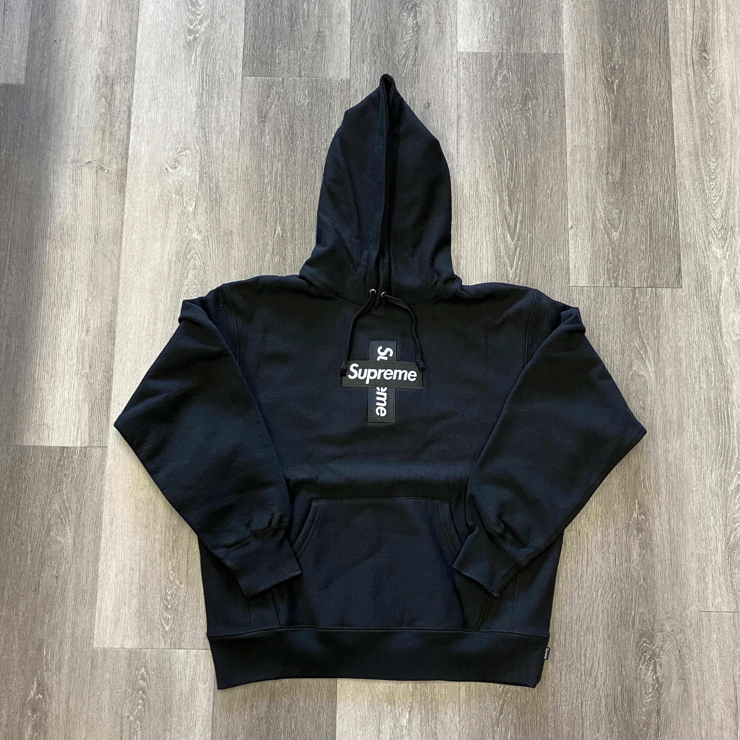 Black Supreme Cross Box logo hooded sweatshirt with front pocket and adjustable drawstring hood, brand new with accessories included.