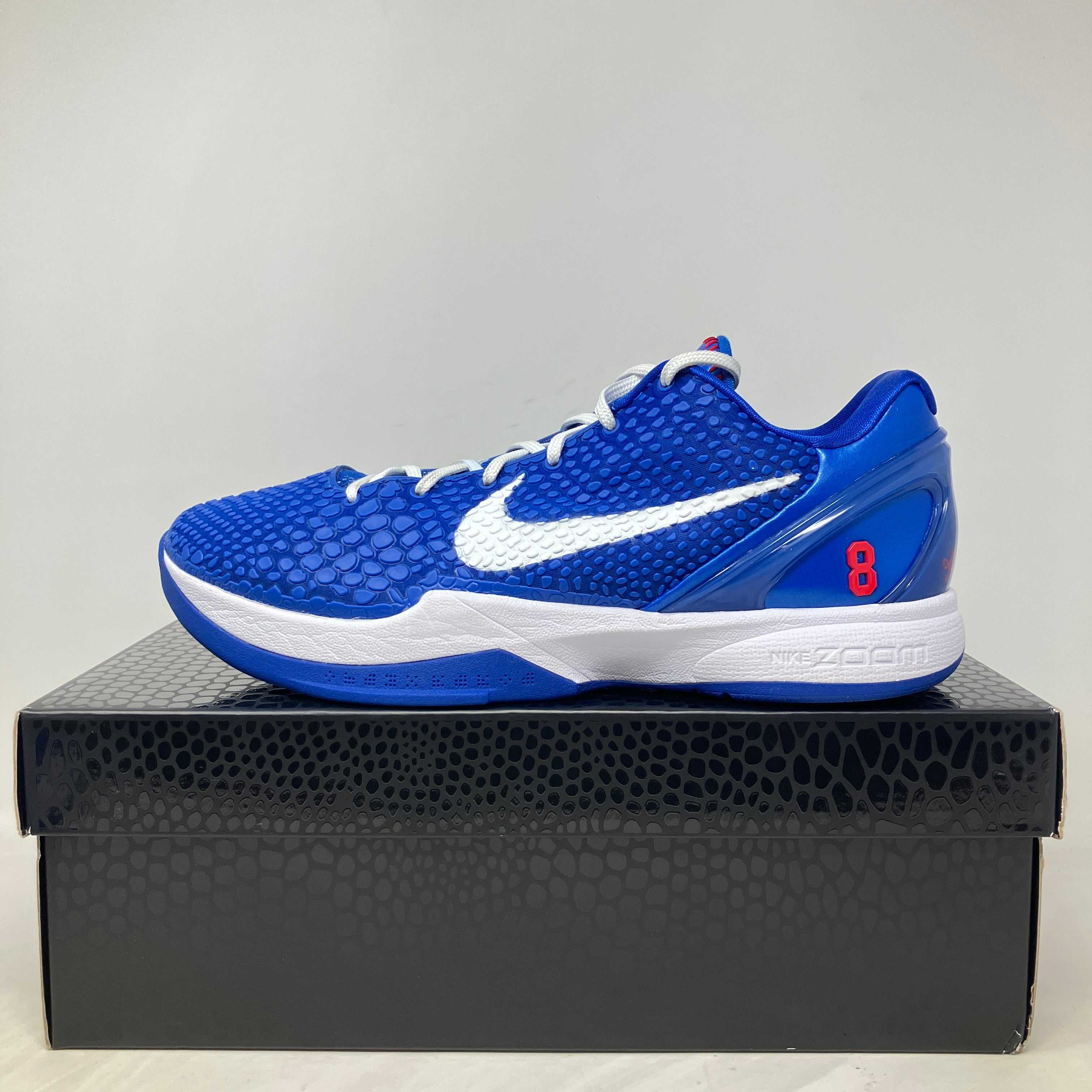 Blue Nike Kobe 6 Protro Dodgers basketball shoe on black box, pre-owned with all accessories included