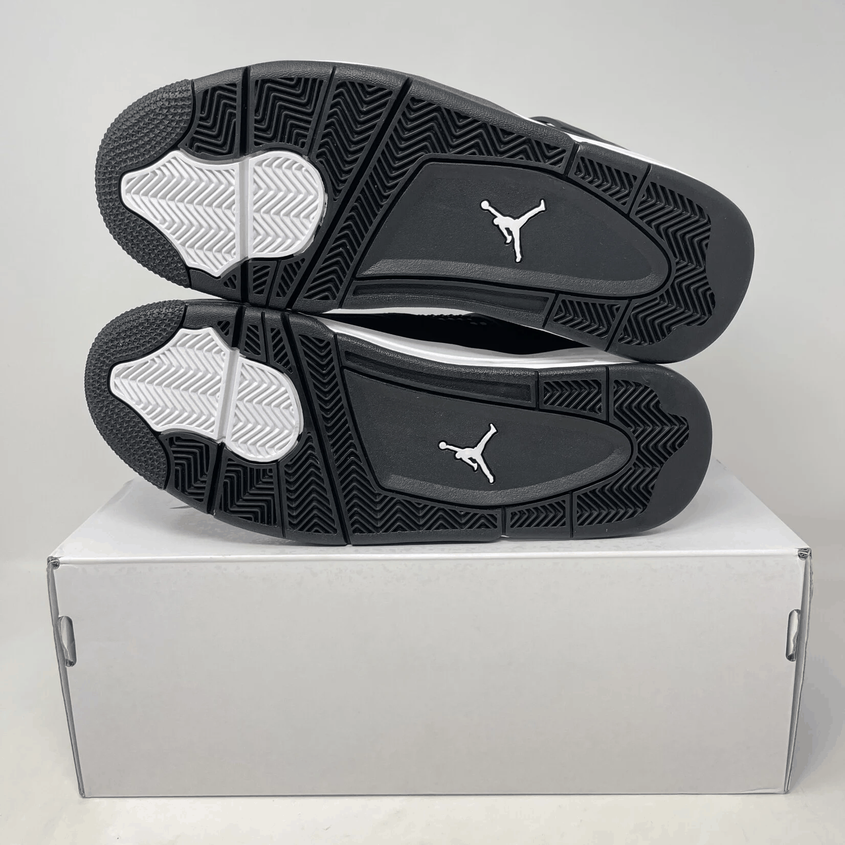 Jordan 4 Retro White Thunder sneakers on box, brand new condition.