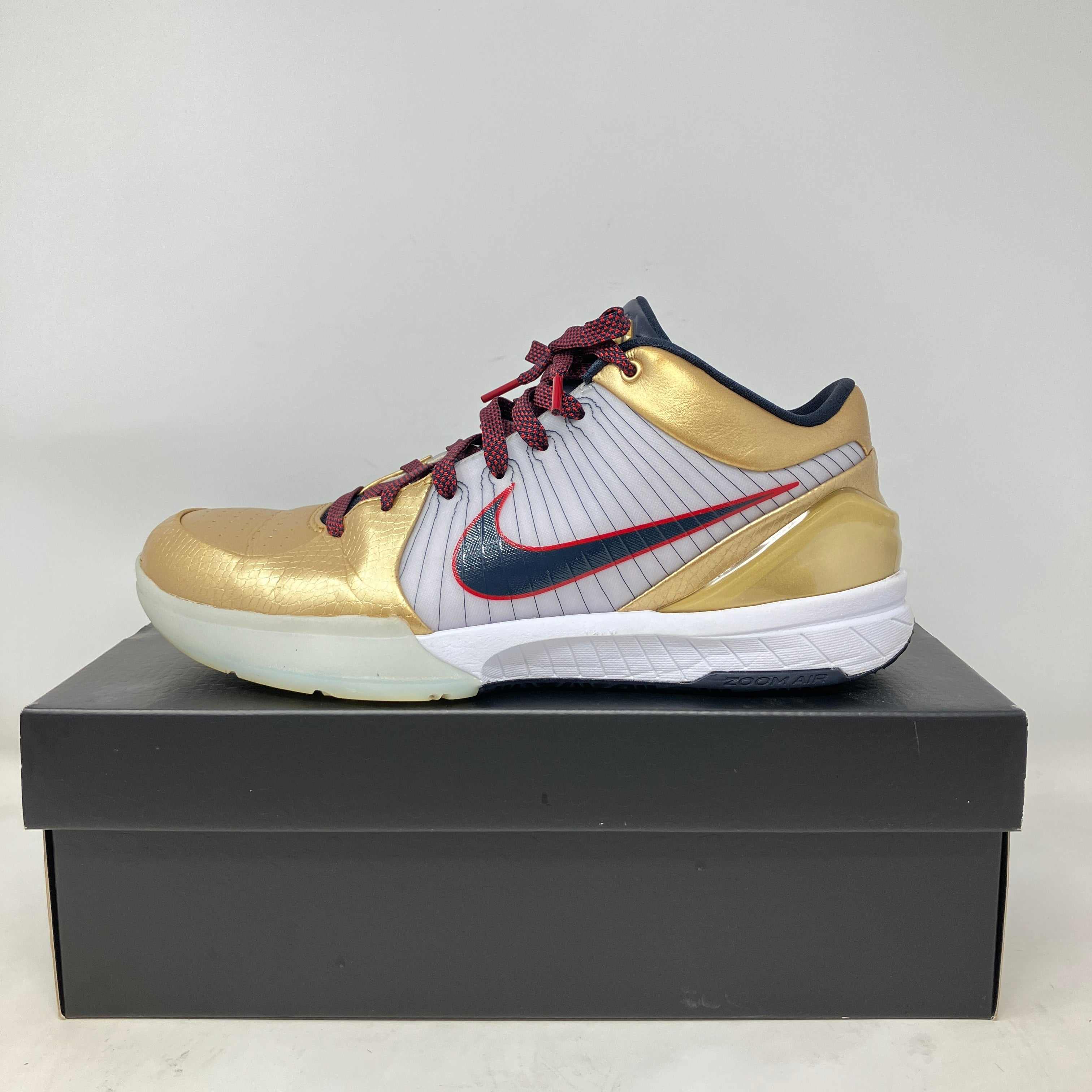 Nike Kobe 4 Protro Gold Medal 2024 basketball shoe in gold and white on black box, pre-owned with accessories included