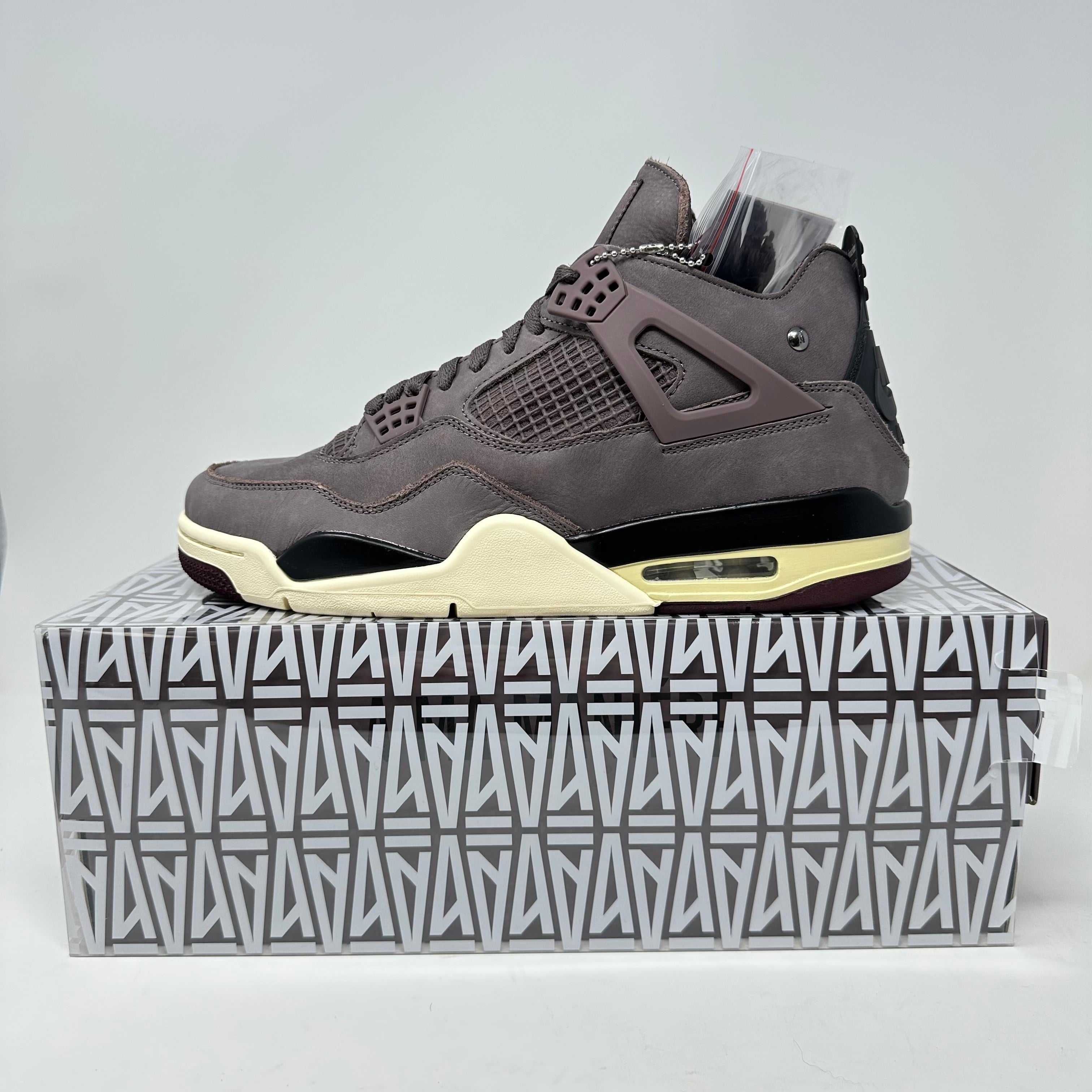Jordan 4 Retro A Ma Maniére Violet Ore sneaker in brand new condition with complete accessories displayed on branded box