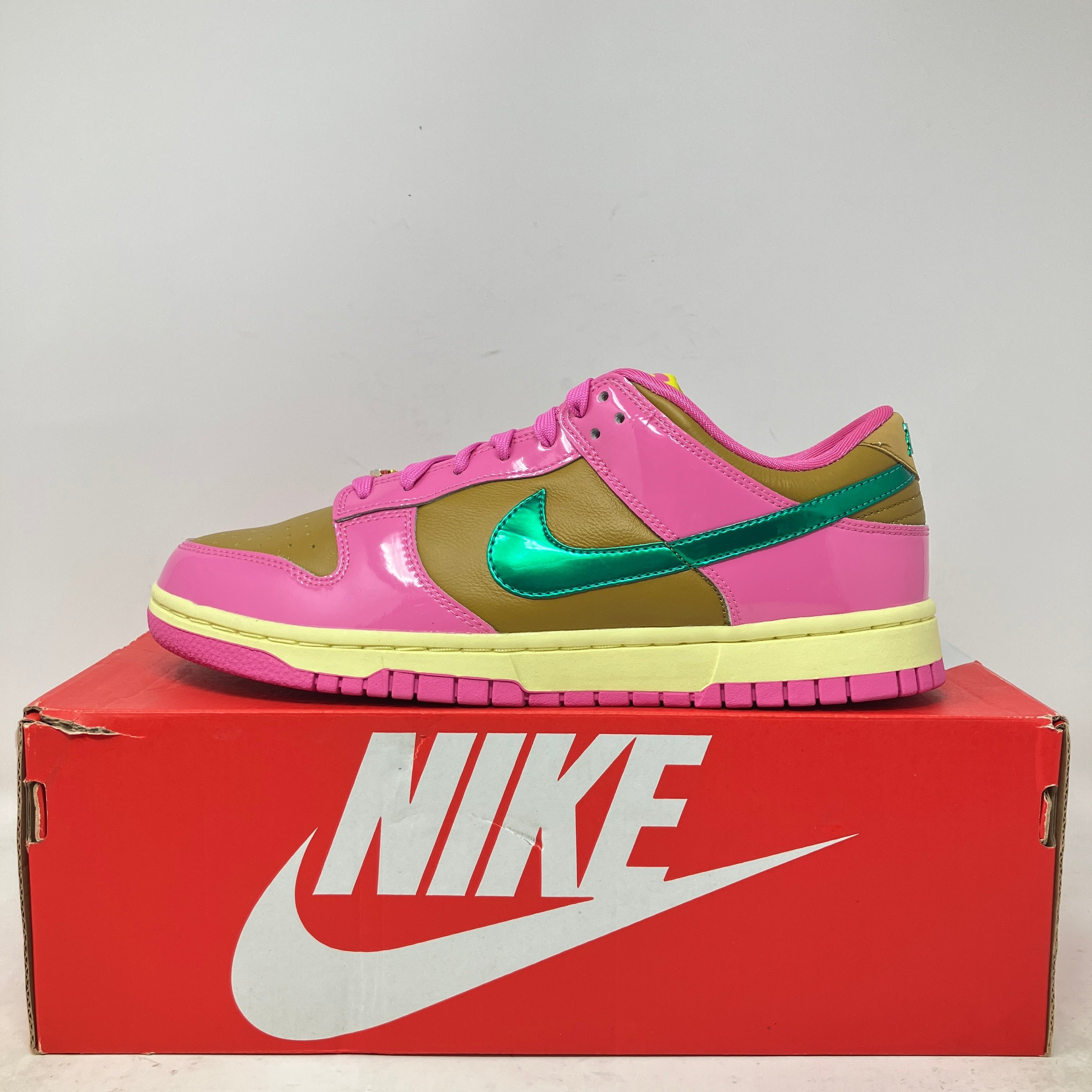 Nike Dunk Low QS Parris Goebel sneaker in pink, green, and tan on red Nike box, brand new with accessories included