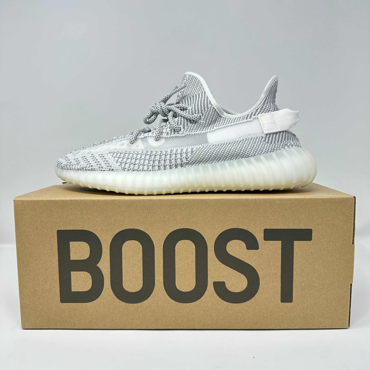 adidas Yeezy Boost 350 V2 Static sneaker in grey and white knit with translucent midsole and textured sole on a BOOST box
