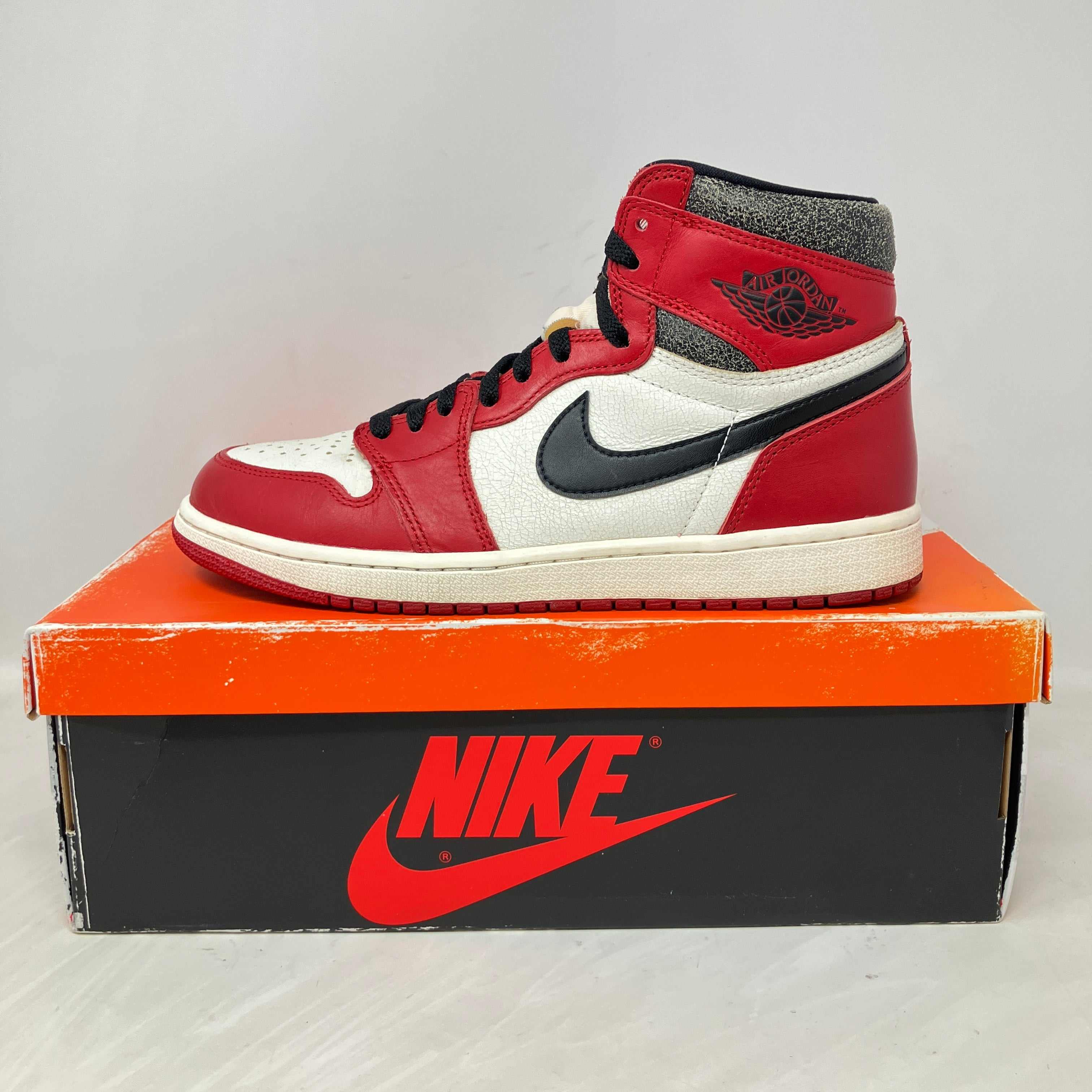 Jordan 1 Retro High OG Chicago Lost and Found sneaker on Nike box, pre-owned with all accessories