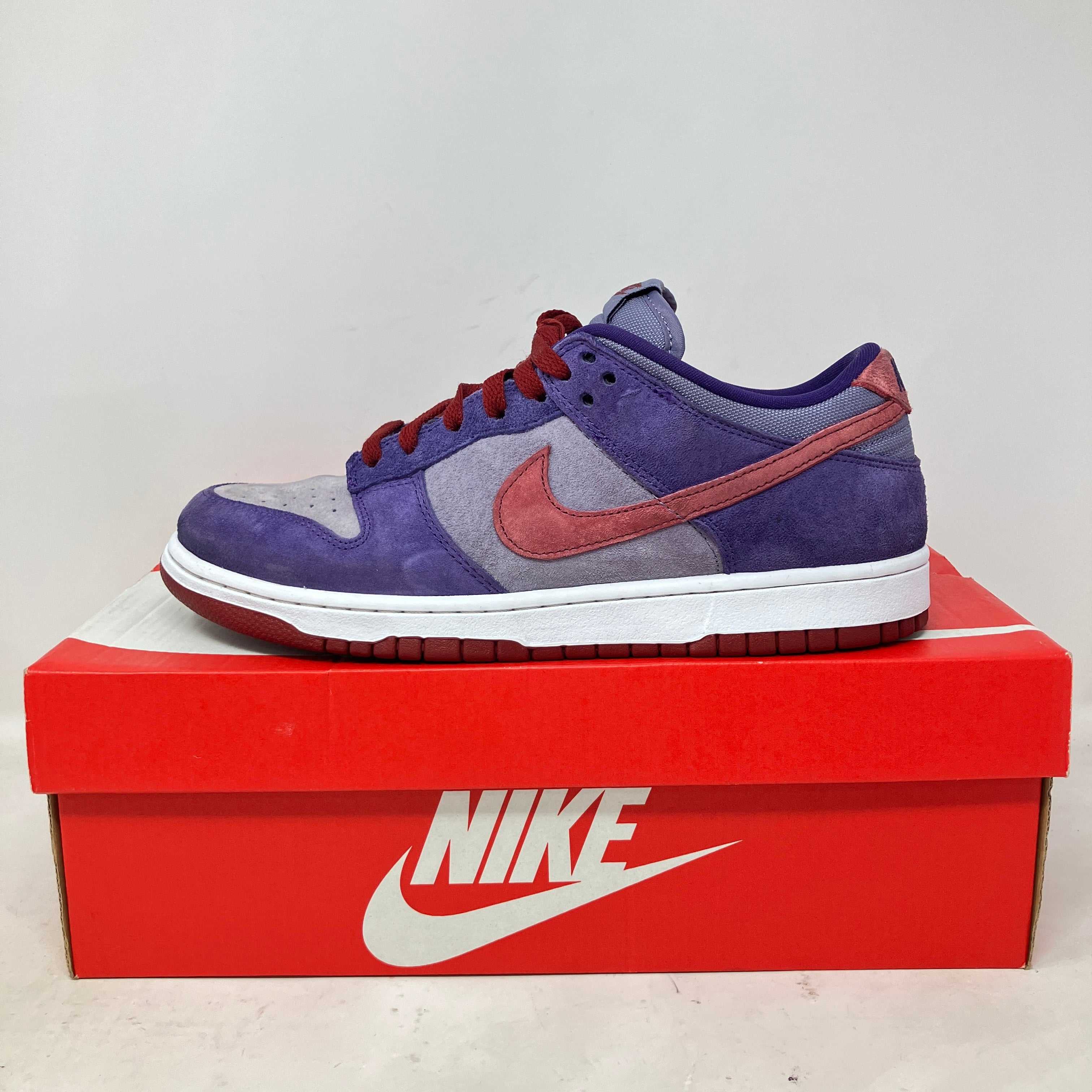 Nike Dunk Low Plum sneaker in purple and red on red Nike shoebox