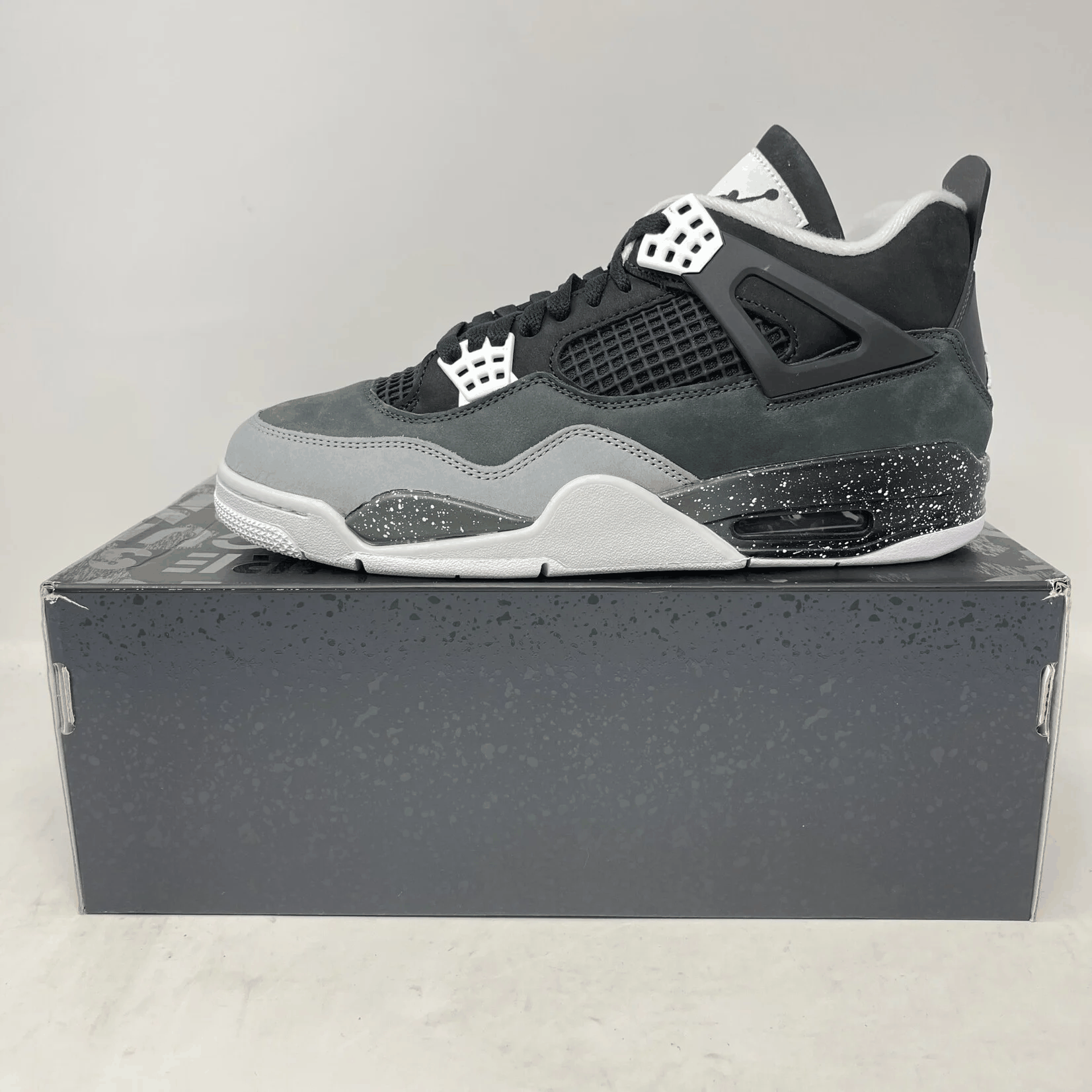 Jordan 4 Retro Fear 2024 sneaker in black and grey on box, brand new with all accessories included