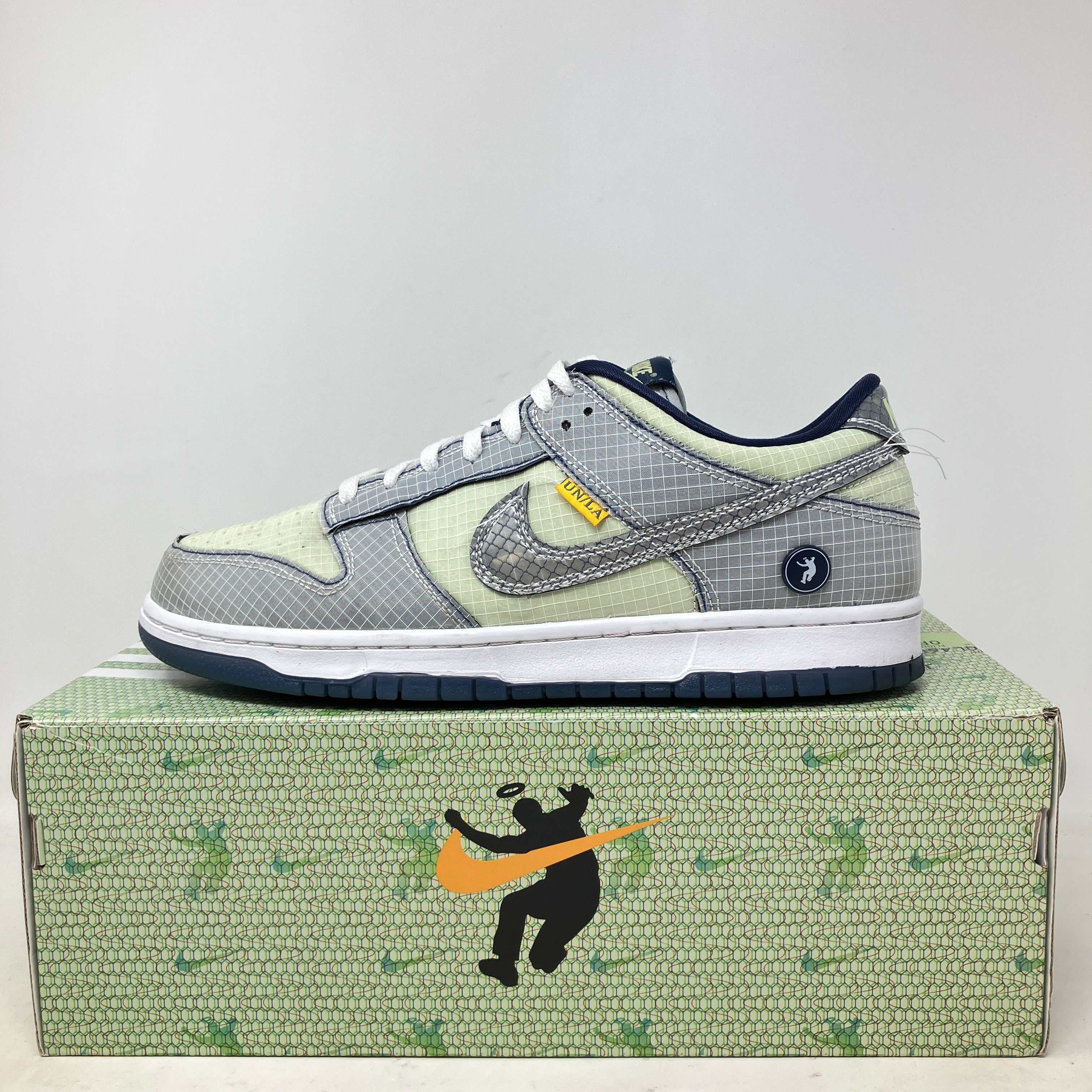 Nike Dunk Low Union Passport Pack Pistachio sneaker on branded shoe box with accessories included