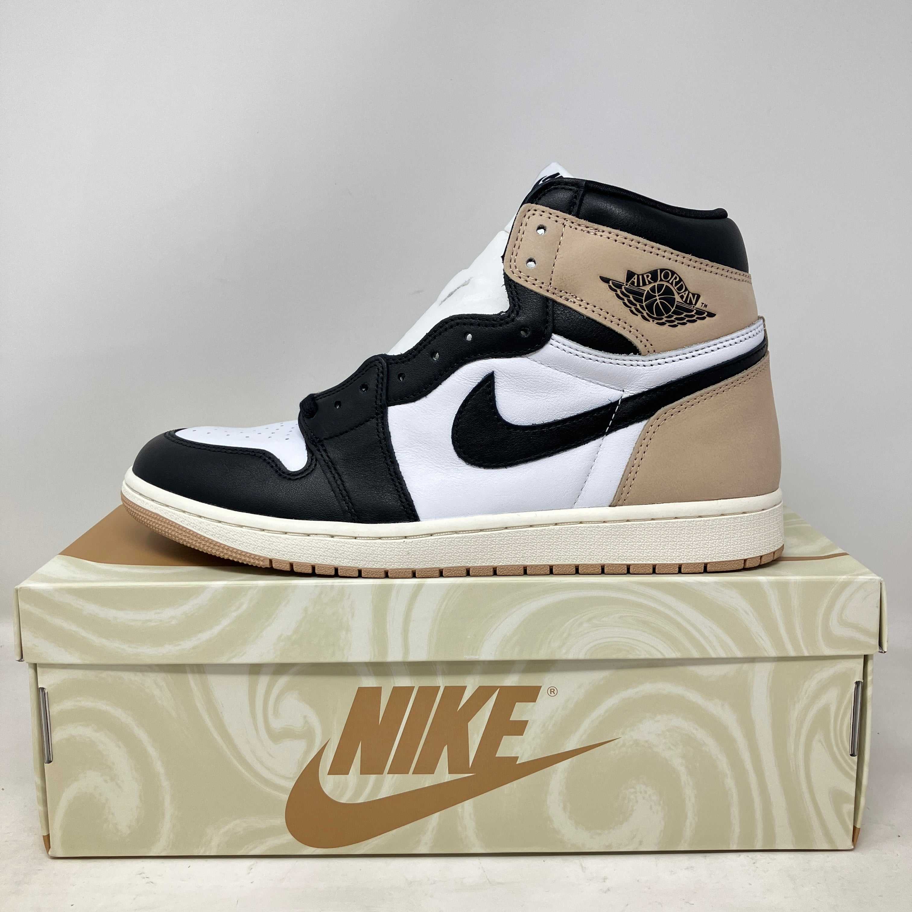 Jordan 1 Retro High OG Latte women's sneaker in black, white, and tan on Nike box