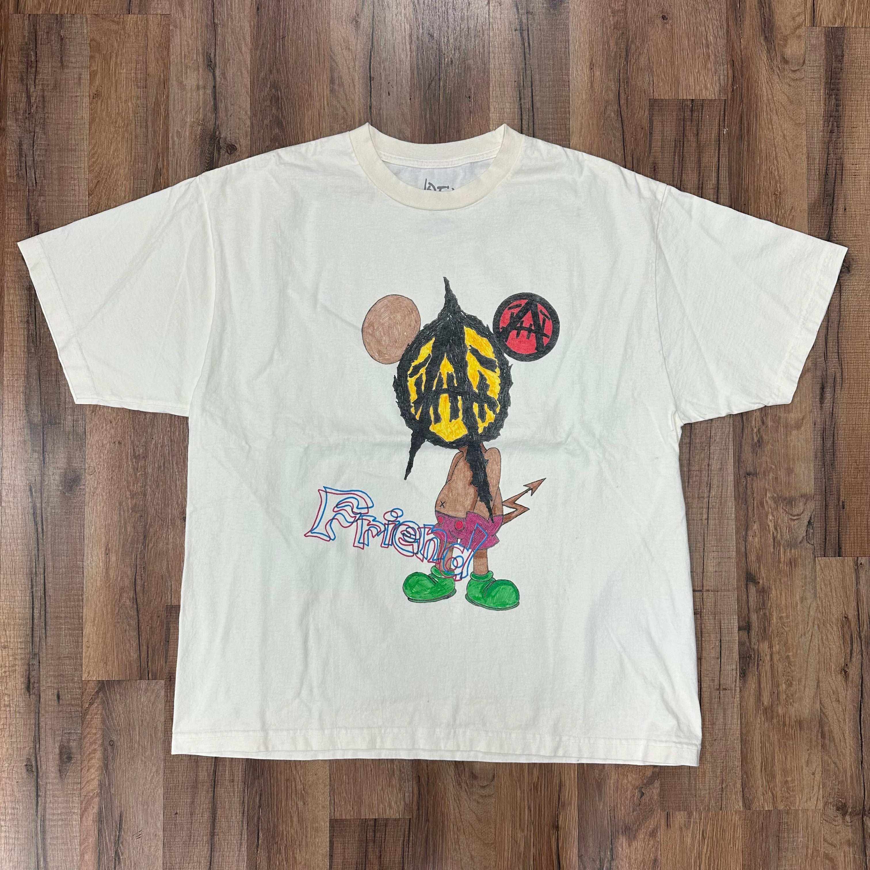 White Travis Scott Utopia x St Michael 2A graphic tee with colorful cartoon design and "Friend" text.