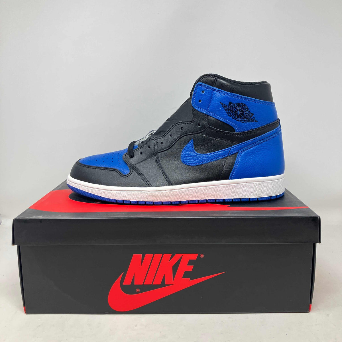 Jordan 1 Retro Royal sneaker in black and royal blue leather with white midsole and classic Nike swoosh design.