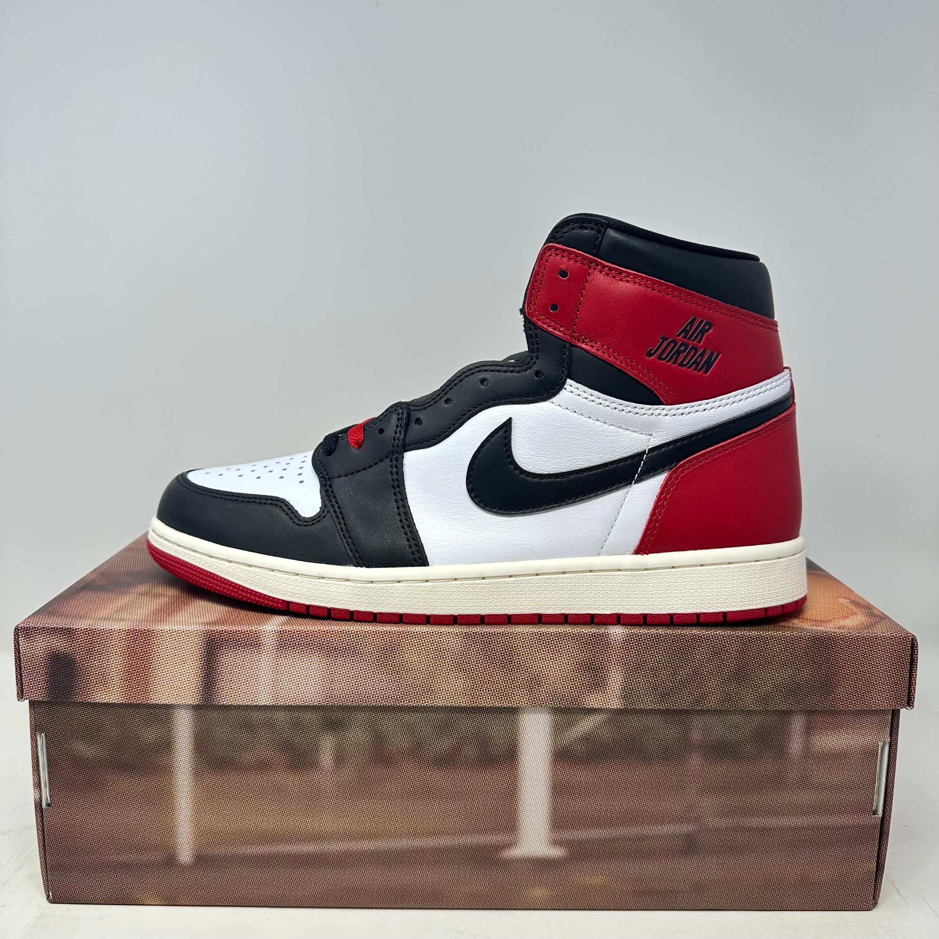 Jordan 1 Retro High OG Black Toe Reimagined sneaker in size 12 brand new with a damaged box lid and all accessories included.