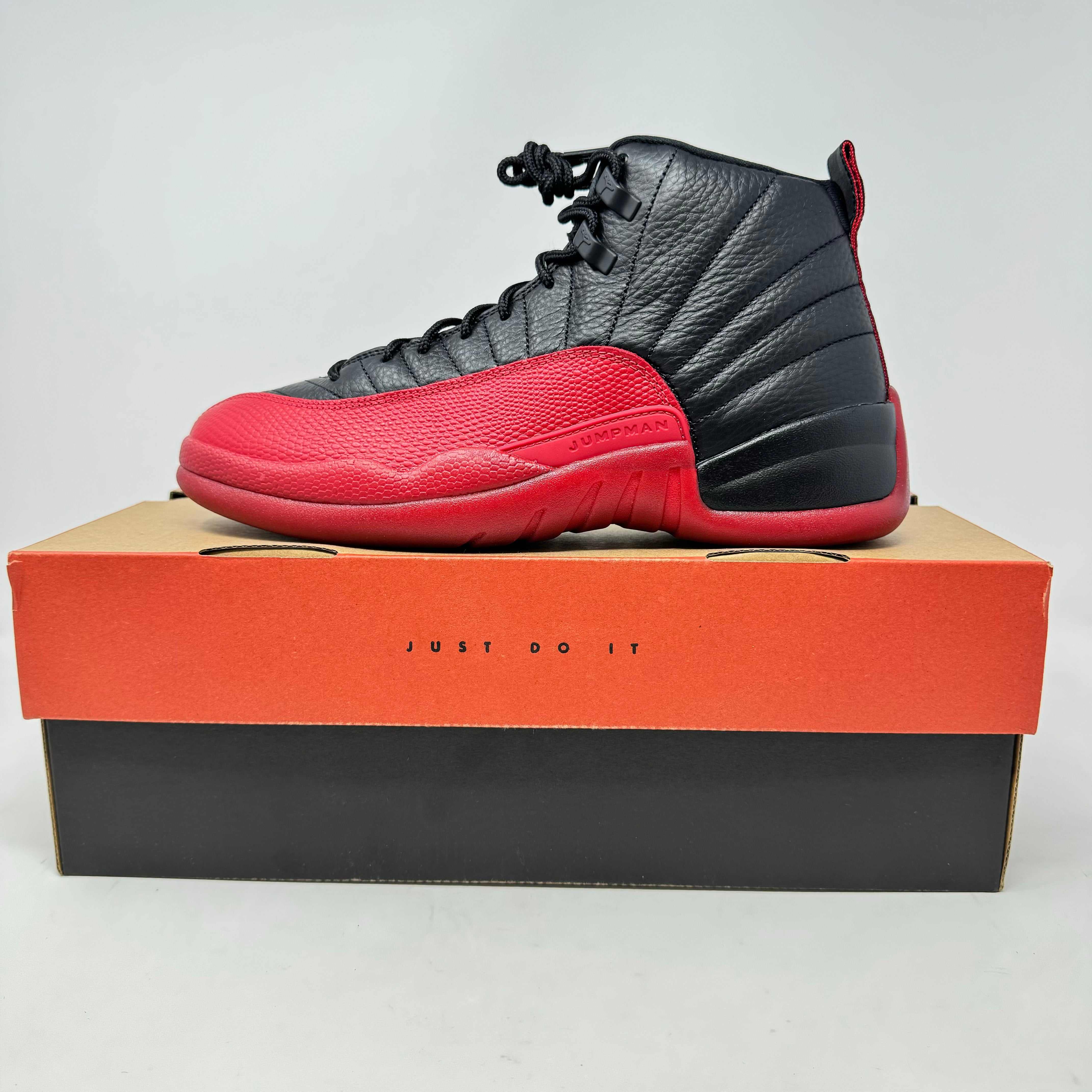 Jordan 12 Retro Flu Game 2025 sneaker in black and red on box with label Just Do It