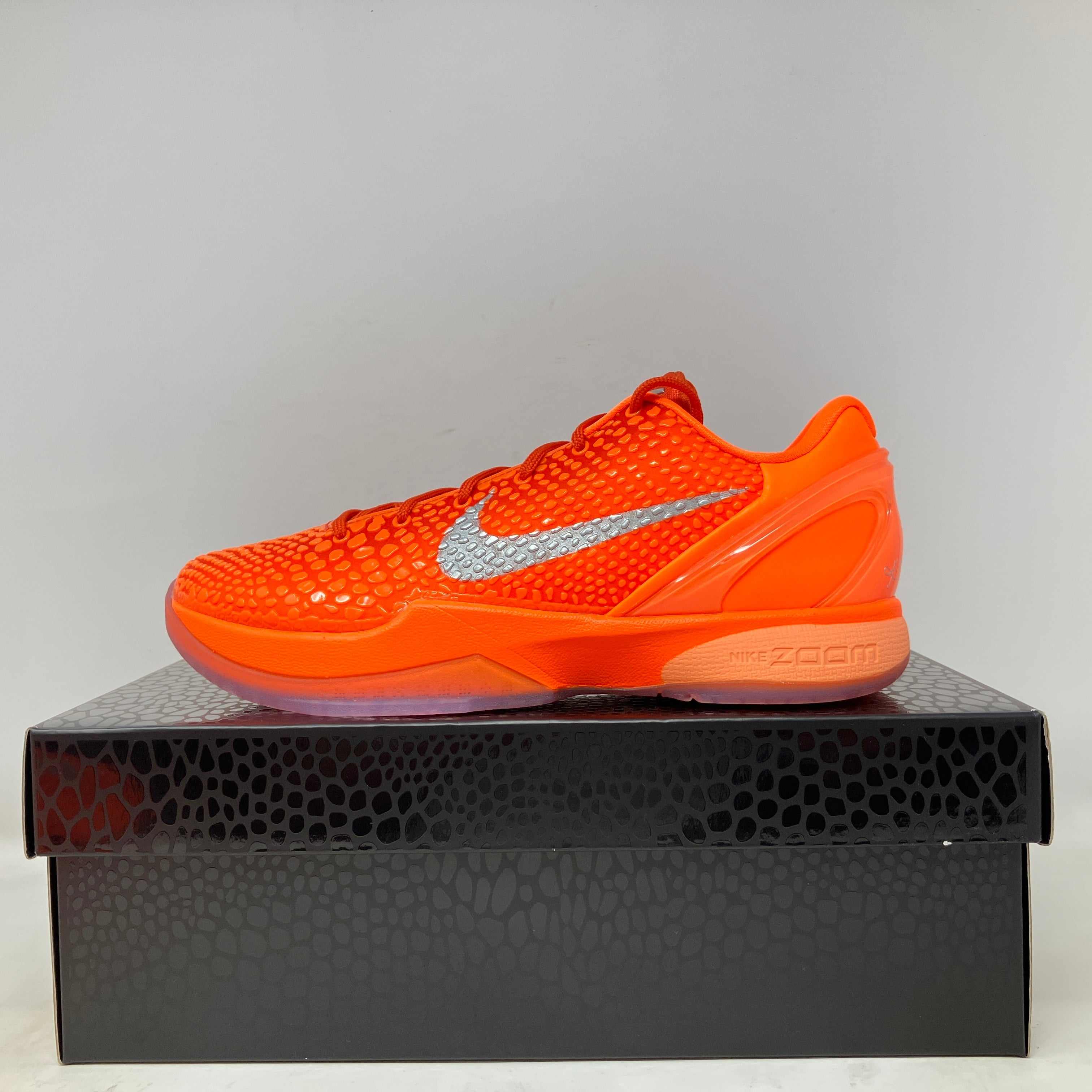 Nike Kobe 6 Protro Total Orange basketball shoe on black textured box, brand new with all accessories included