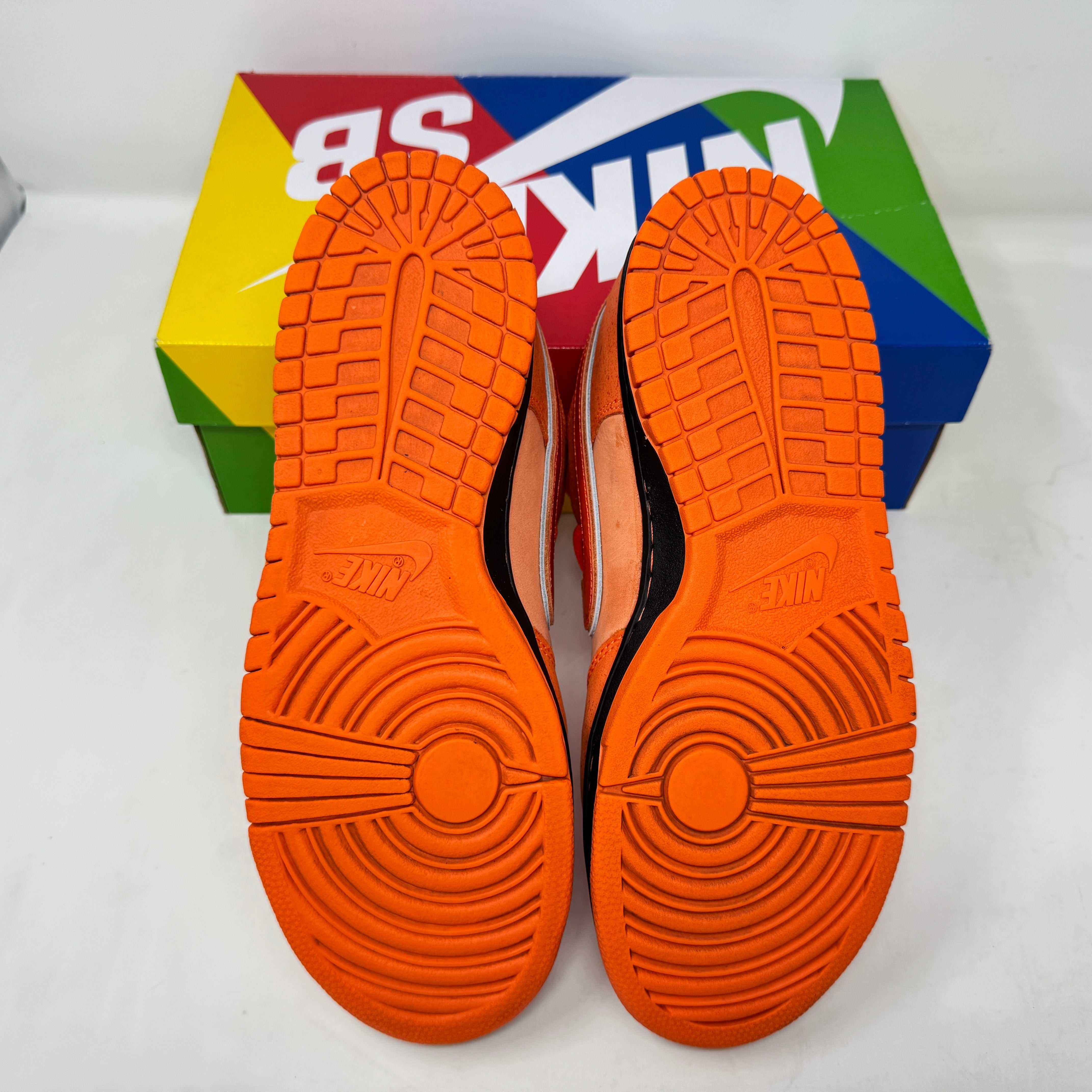 Nike SB Dunk Low Concepts Orange Lobster sneakers pre-owned with complete accessories, missing rubber bands, on colorful Nike SB box.