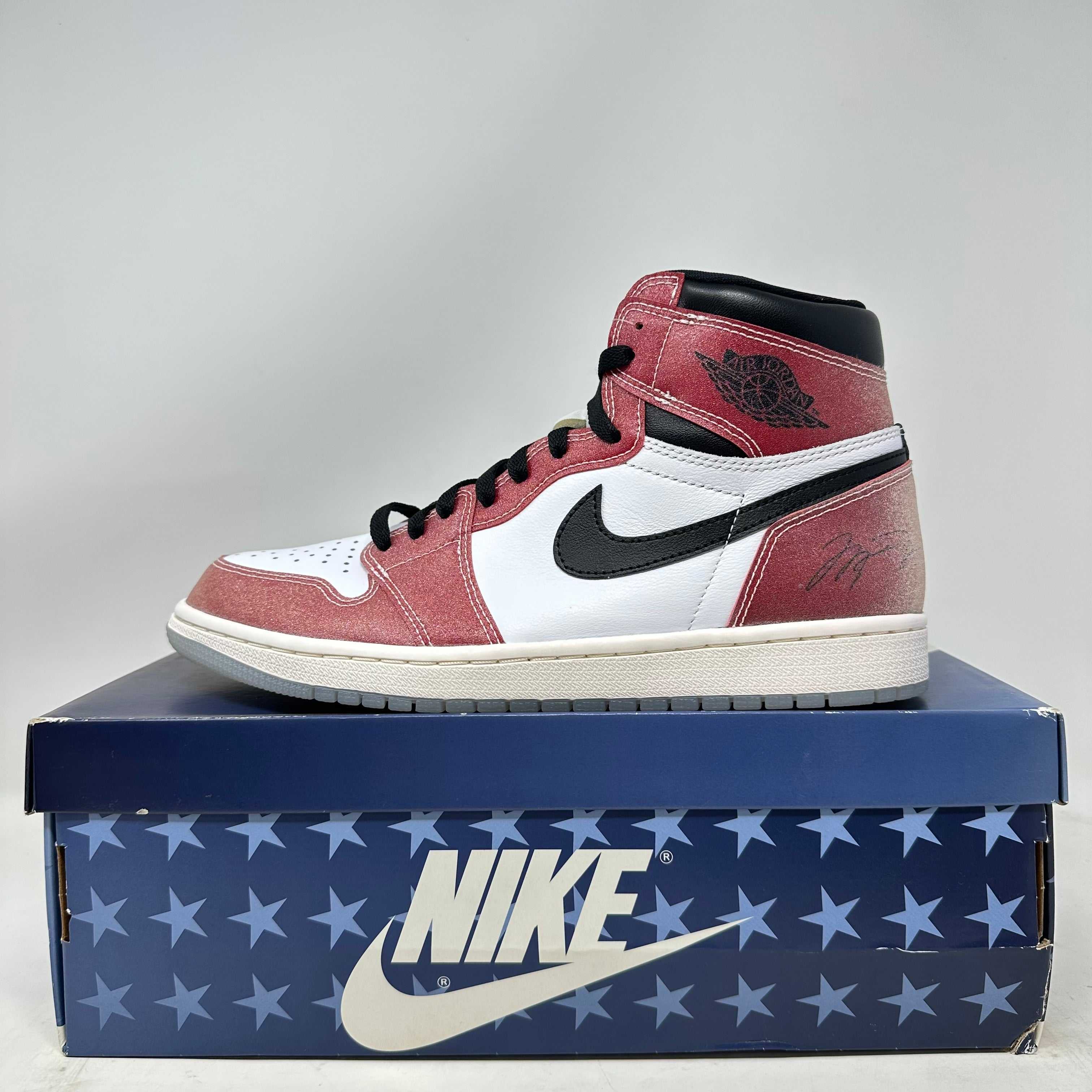 Jordan 1 Retro High Trophy Room Chicago sneaker in red, white, and black on a blue Nike star-patterned box, brand new condition