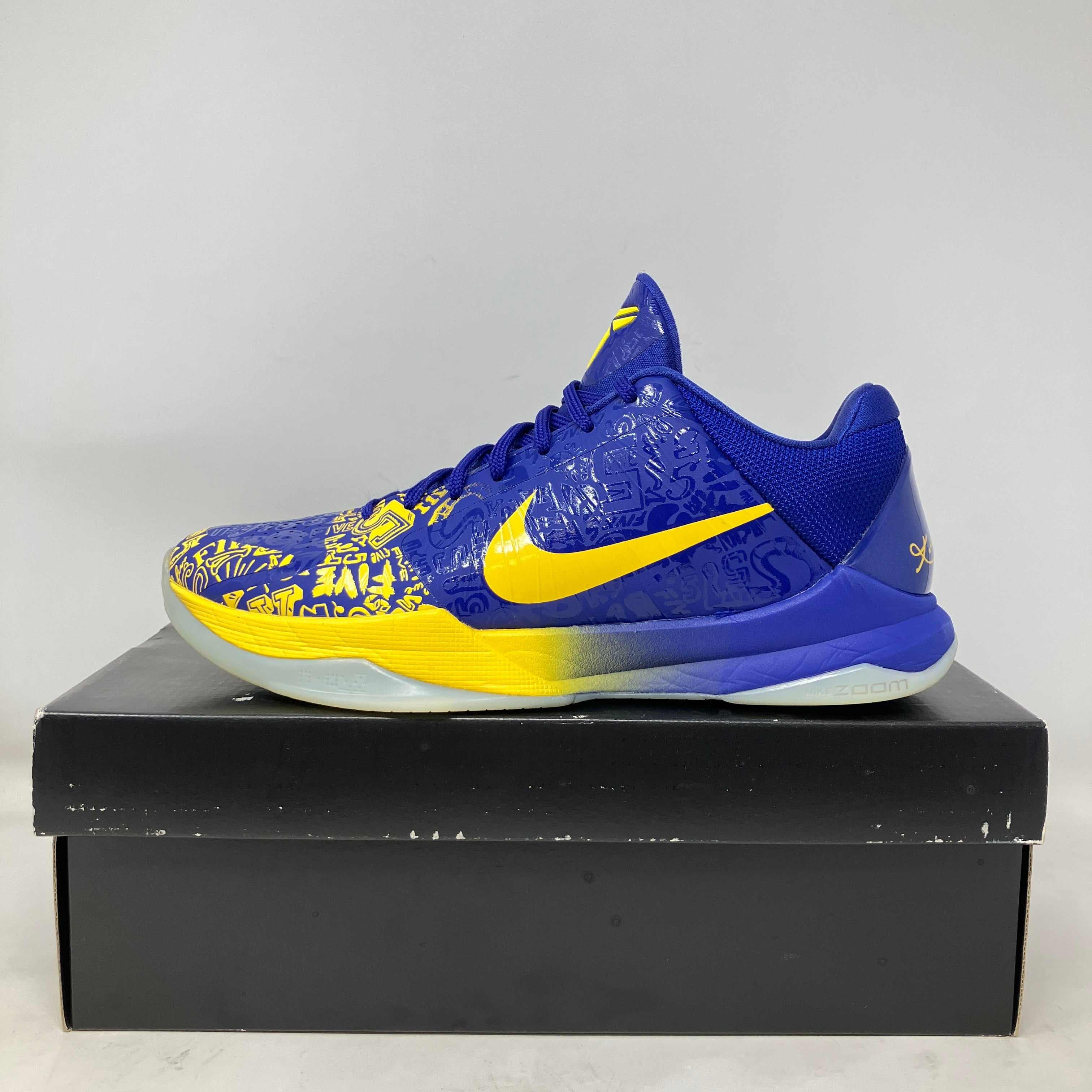 Nike Kobe 5 Protro 5 Rings 2020 blue and yellow basketball shoe side view on black box, pre-owned with all accessories included