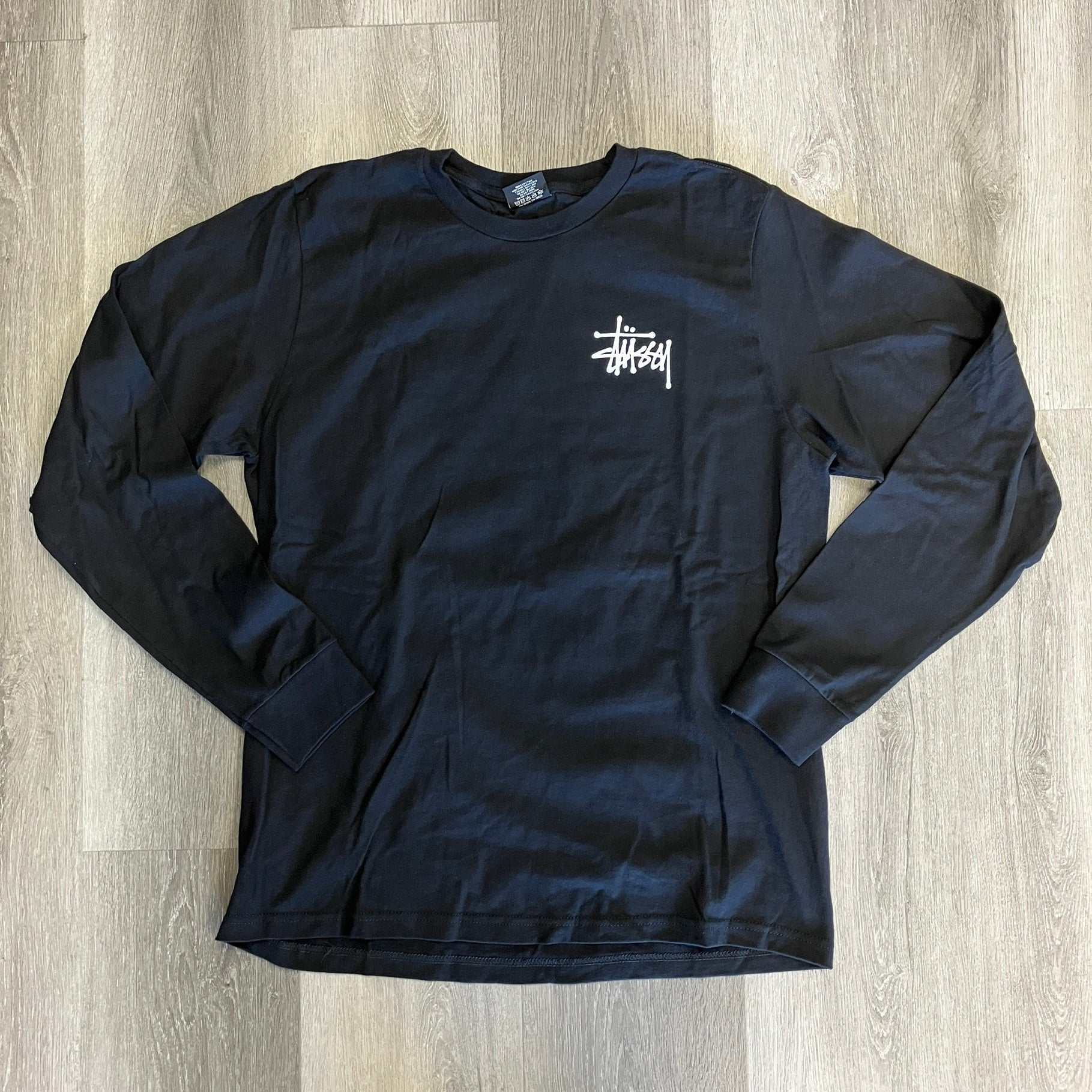 Black Stussy long sleeve tee with white logo on chest, brand new, size with 20" pit to pit and 26" length