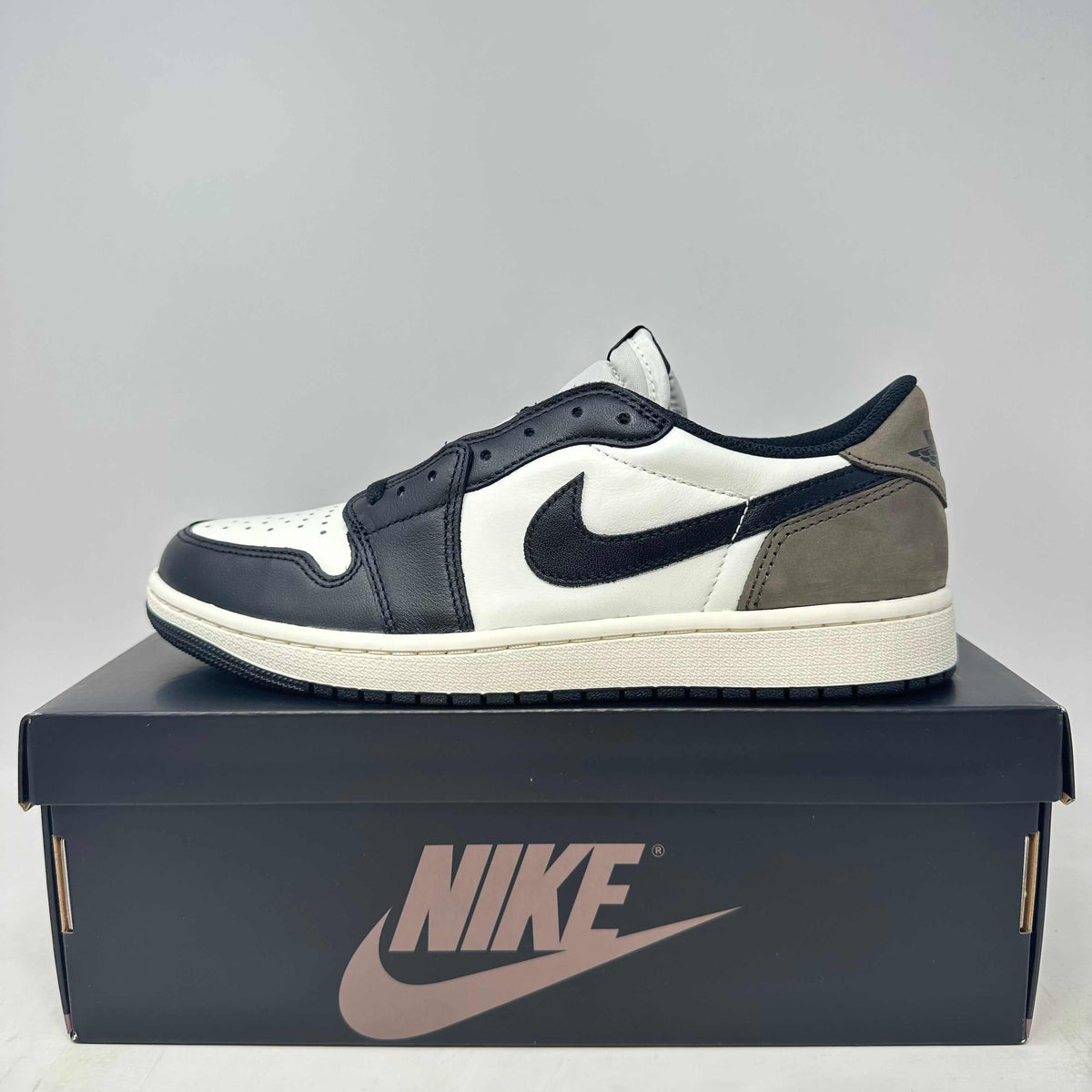 Jordan 1 Retro Low OG Mocha sneaker in black, white, and mocha brown leather with a classic Nike swoosh and low-cut design.