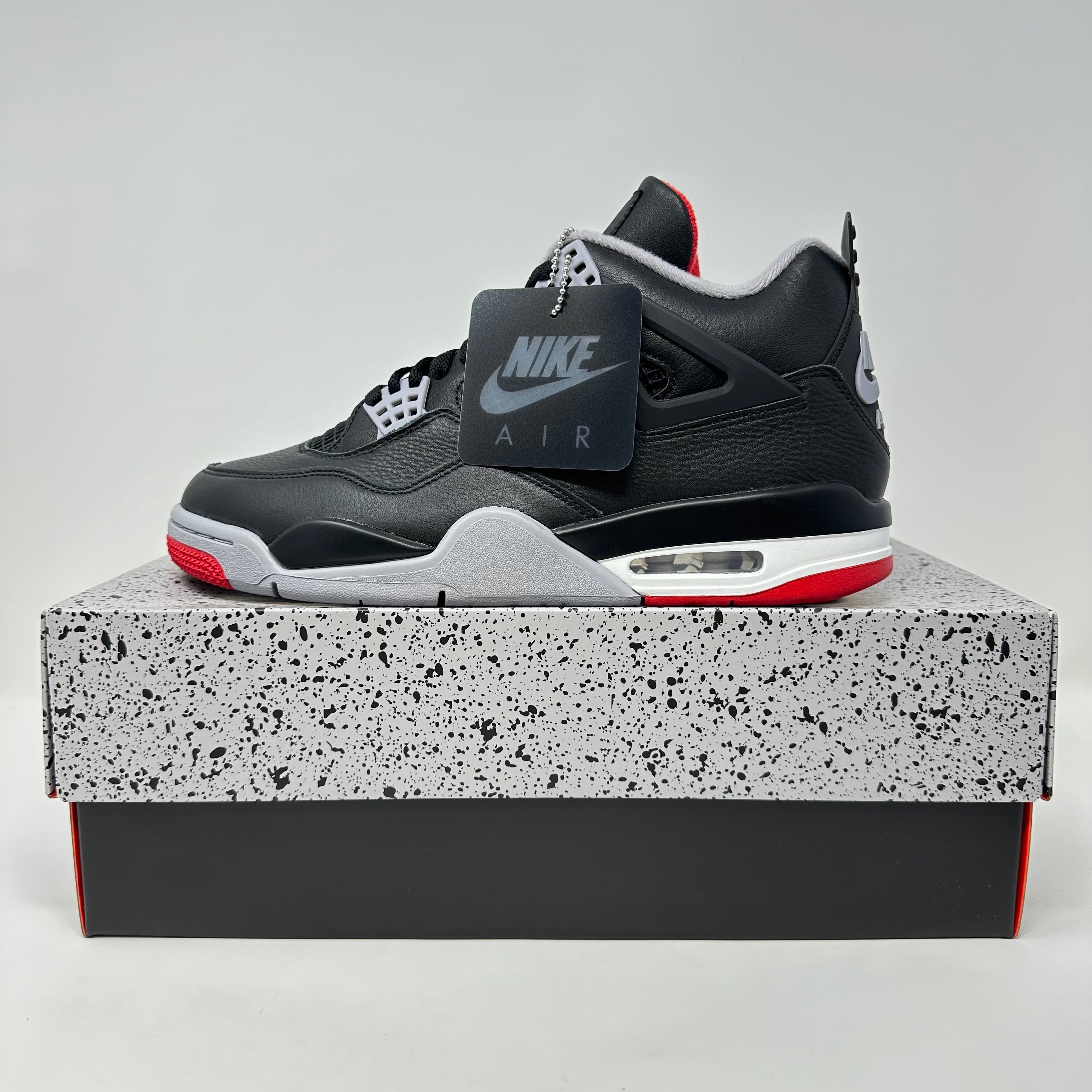 Jordan 4 Retro Bred Reimagined sneaker on box, brand new condition.