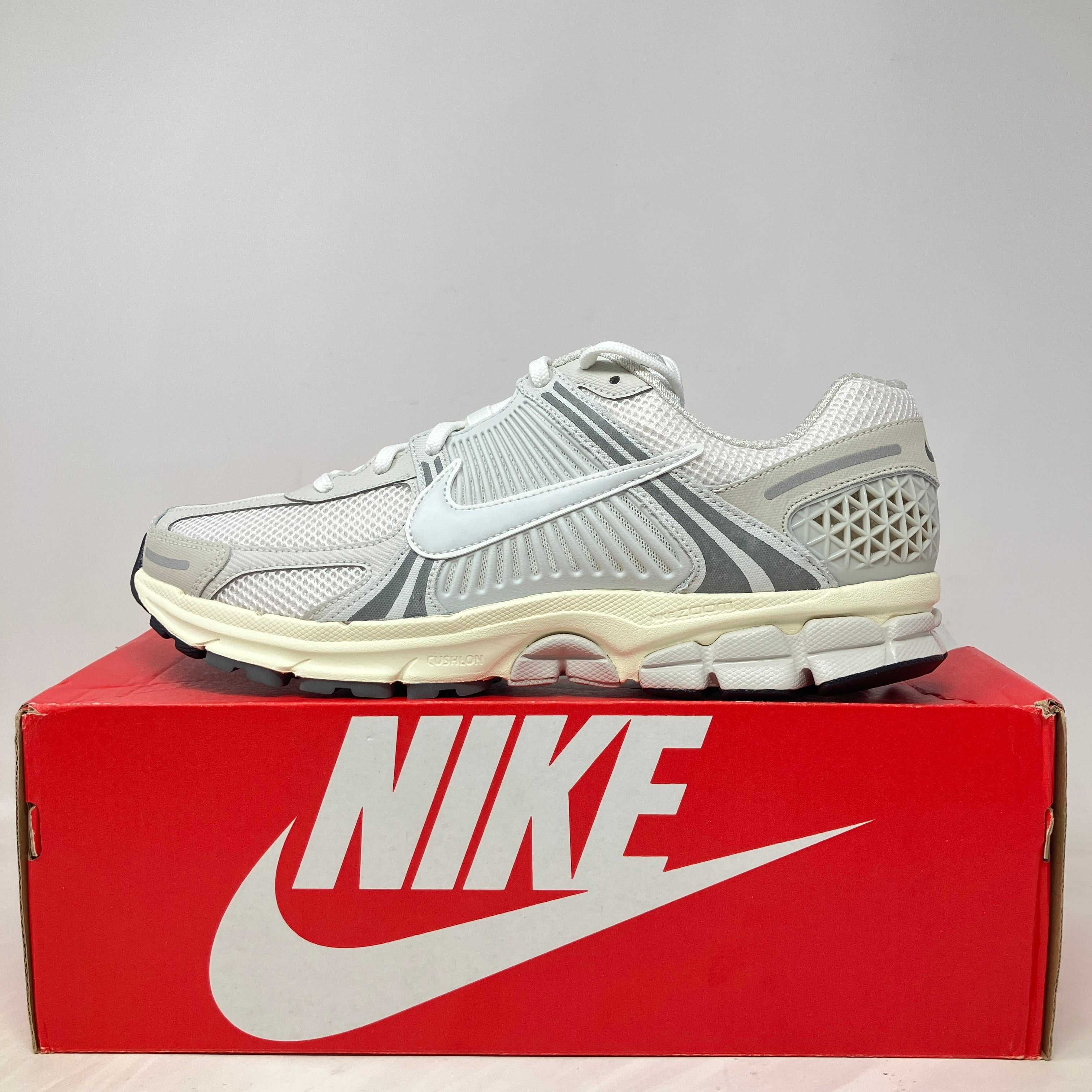 Nike Zoom Vomero 5 Platinum Tint running shoe on red Nike box, brand new with accessories included