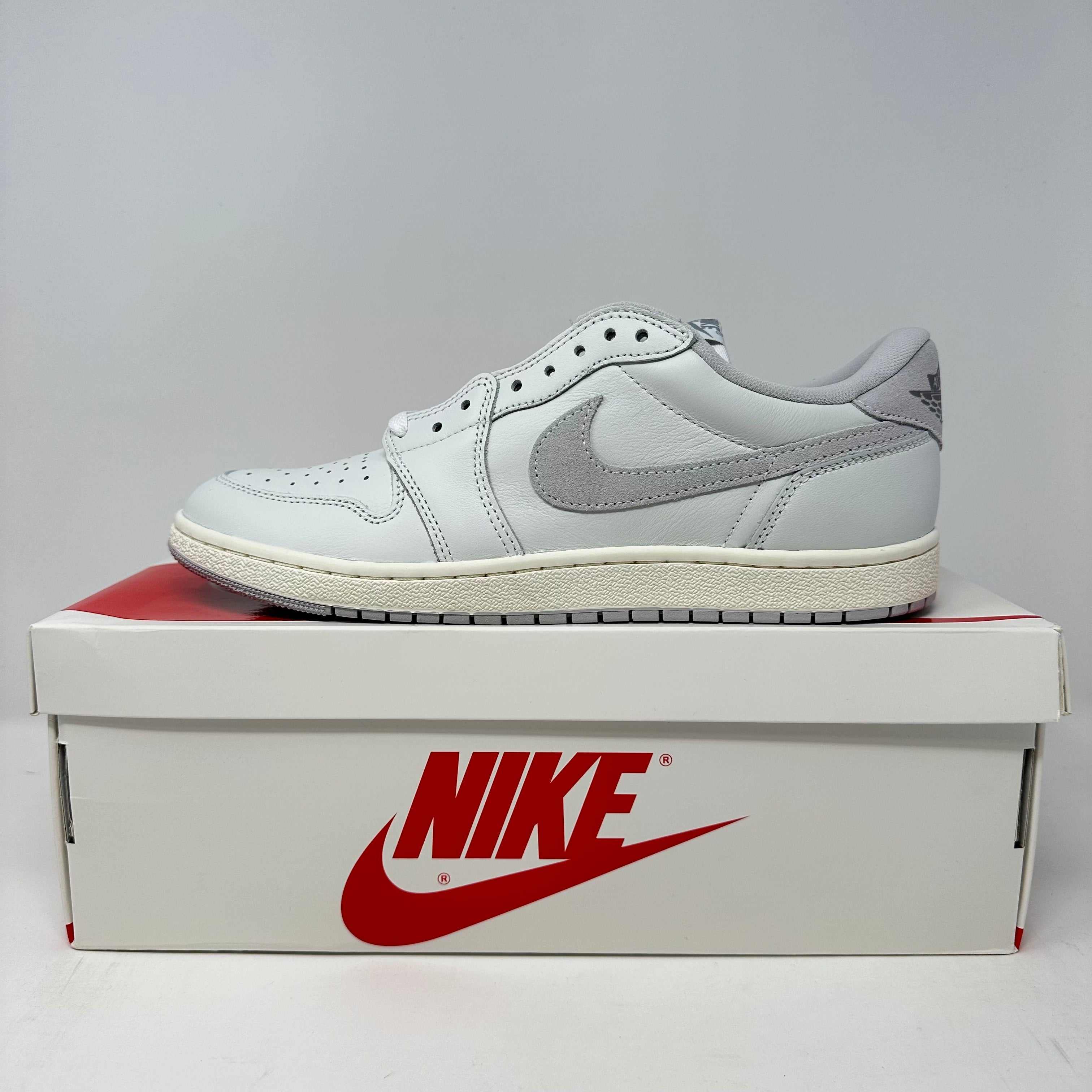 Jordan 1 Retro Low '85 Neutral Grey sneaker on Nike box, brand new condition with accessories included