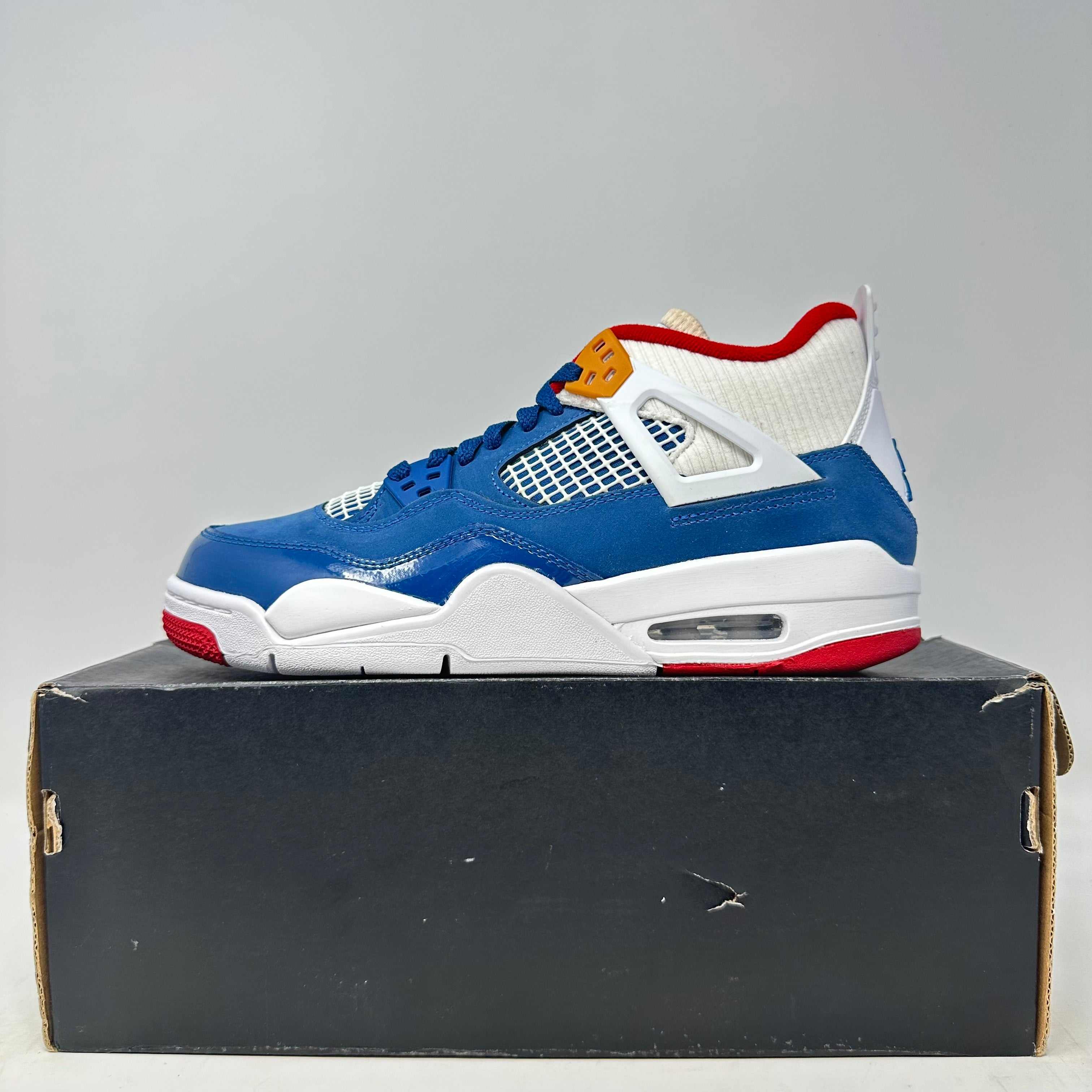 Jordan 4 Retro Messy Room sneaker in blue, white, red on black box, brand new with all accessories
