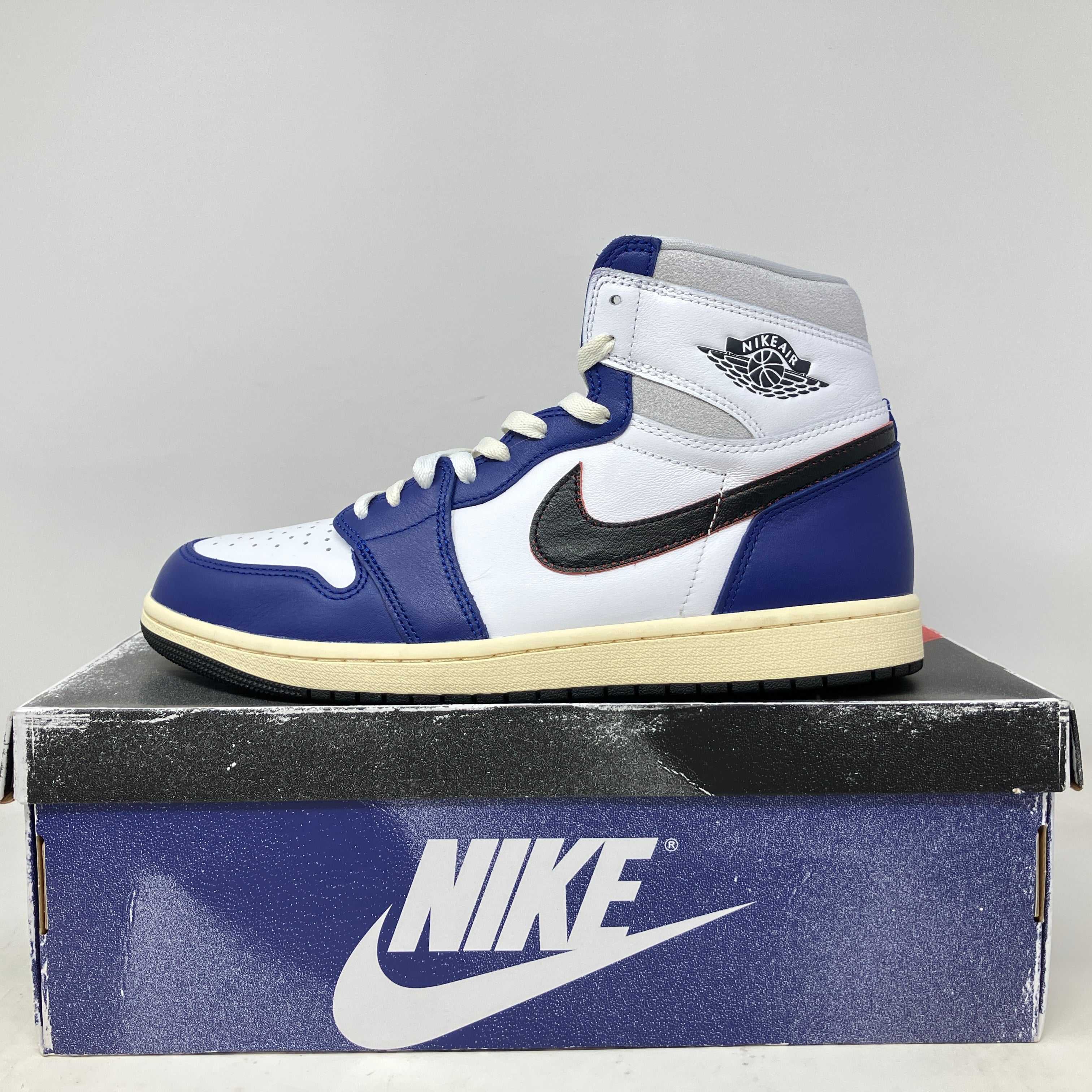 Pre-owned Jordan 1 Retro High OG Rare Air sneaker in white, blue, and black, displayed on a Nike shoebox with all accessories included.