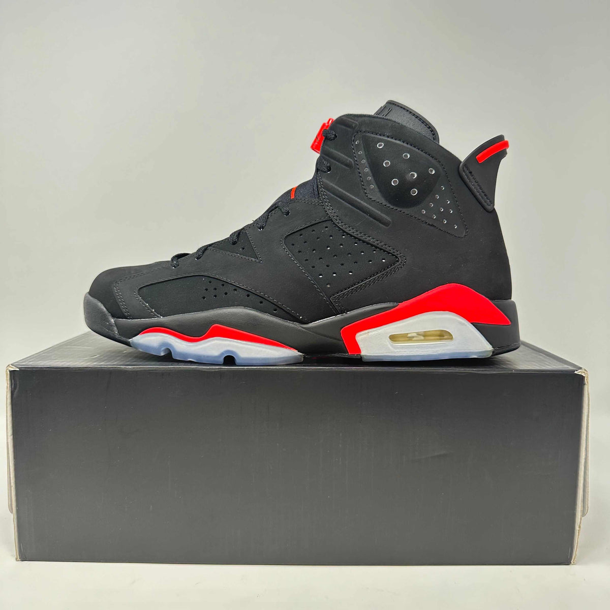 Jordan 6 Retro black and infrared sneaker with nubuck material, perforated panels, and visible air sole unit.